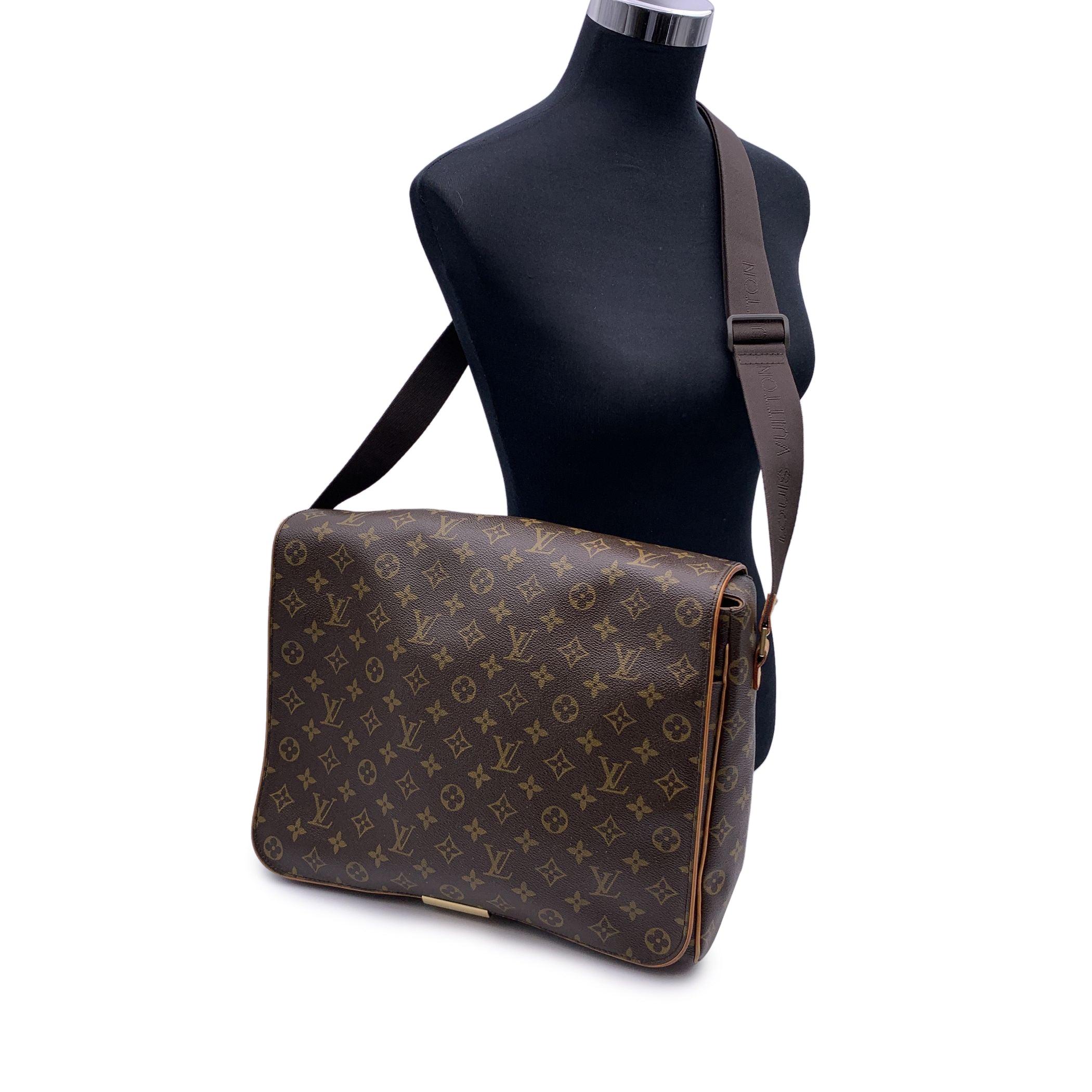 Louis Vuitton Monogram Abbesses GM Shoulder Crossbody Bag. Mod. M45257. Flap with elastic security band closure on the bottom. Leather handle for trolley/travel use on the back. 2 front pockets just under the flap, 1 size big zipper pocket inside,