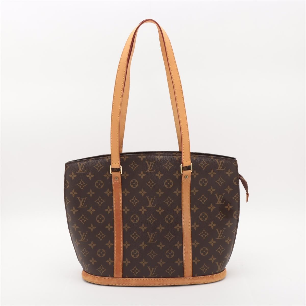 The Louis Vuitton Monogram Babylone Tote Bag is a timeless and practical accessory, perfect for everyday elegance. Crafted from the iconic Monogram canvas with cowhide leather trim, the tote exudes classic sophistication. Its spacious interior