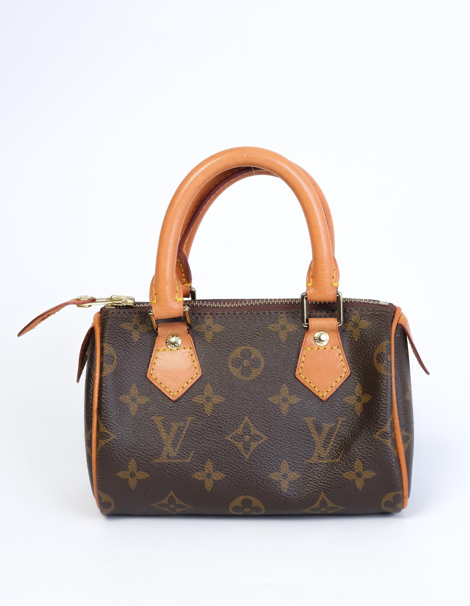 Made with brown monogram canvas and features tanned natural leather finishes, dual rolled top handles, top zip closure and brown woven fabric interior. Comes with an attachable strap (bandouliere means strap in French) for should or crossbody cary.