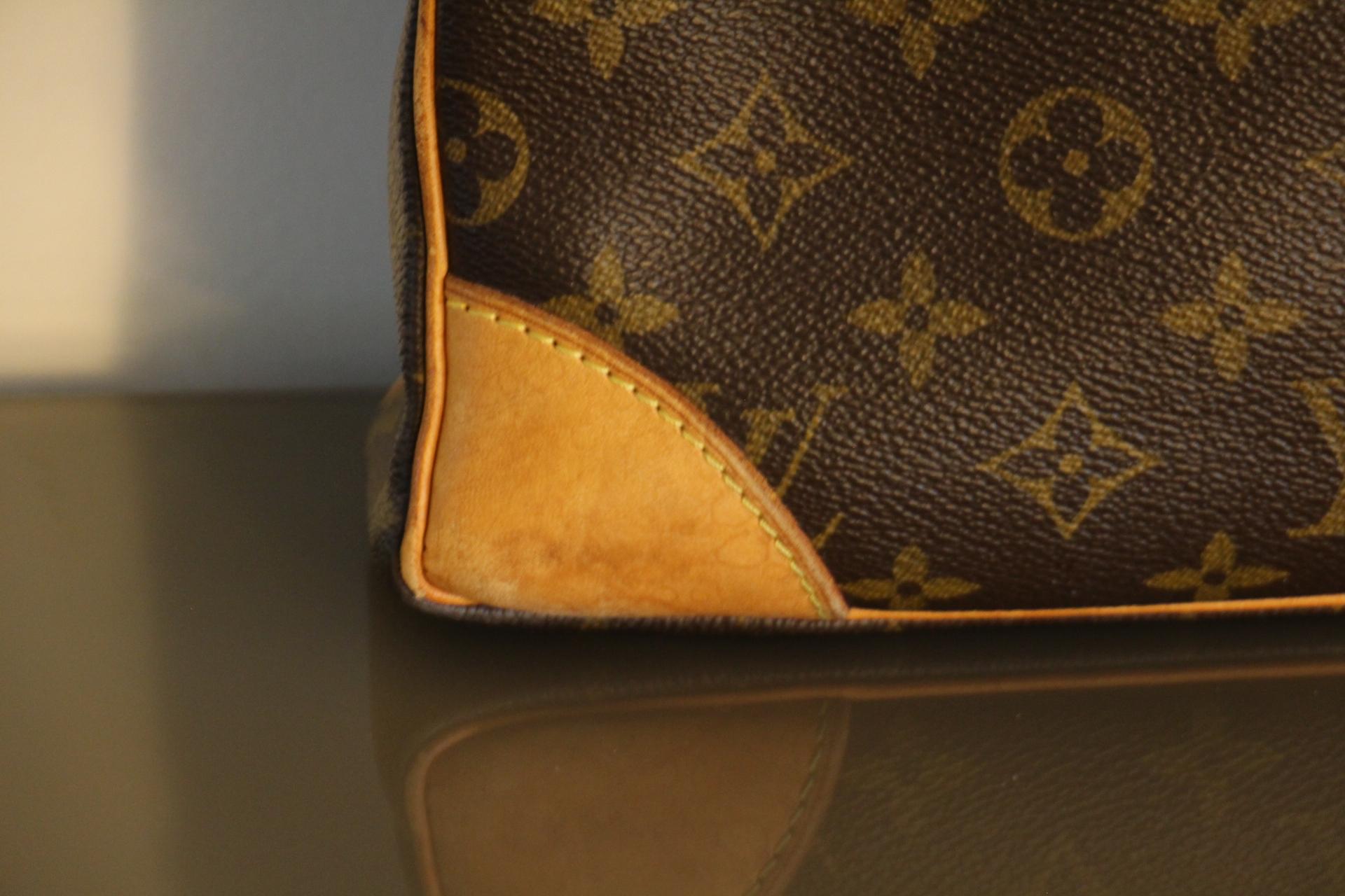  This Louis Vuitton Briefcase bag features Louis Vuitton monogram and cowhide leather, dual rolled leather top handles, one with zip closure and two-way zip closures at top. Its interior is very clean, no stain,no smell. It is printed Louis Vuitton
