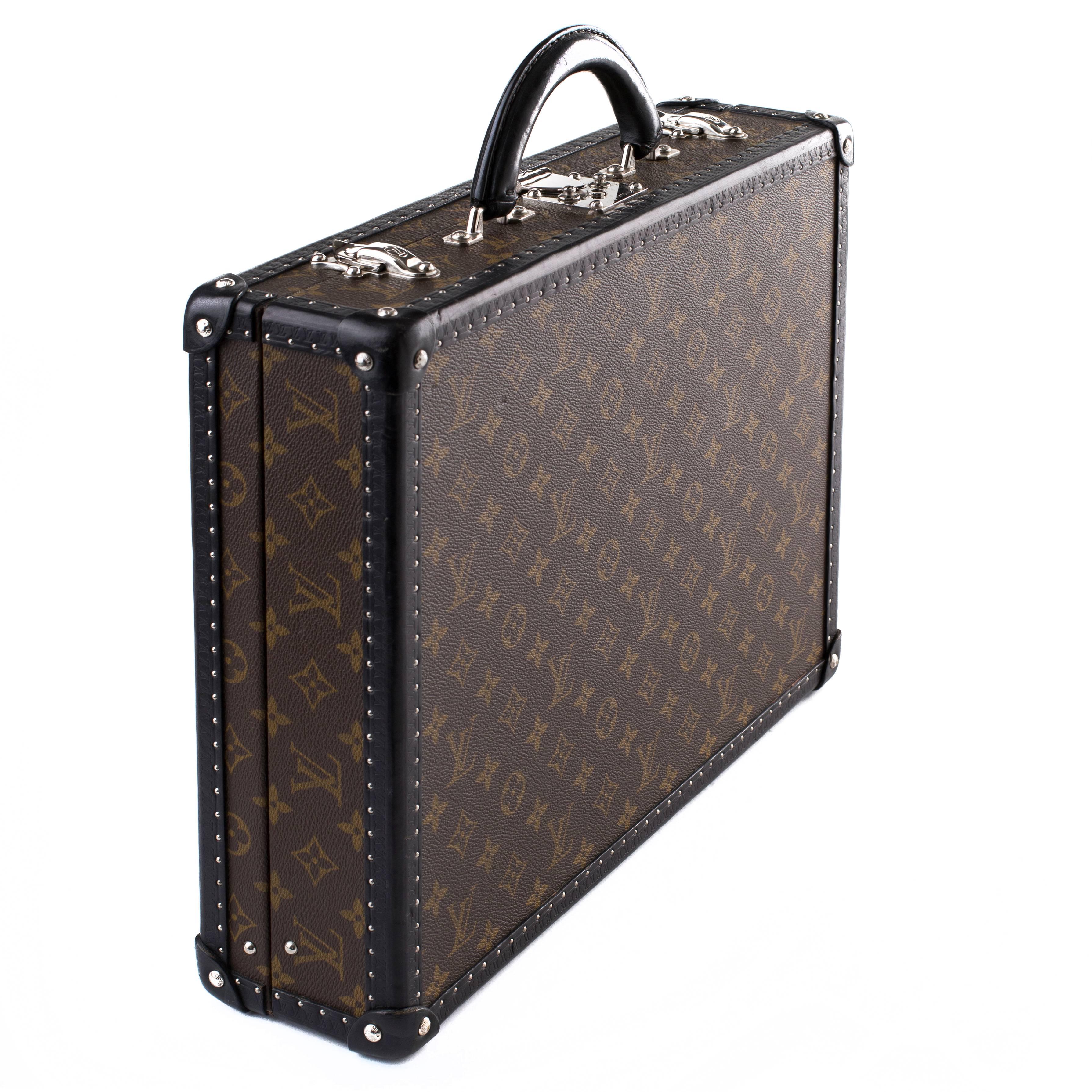 Louis Vuitton Monogram Briefcase with black leather embossed trim.
The embossed trim features silver studded detailing running along all edges of the briefcase.
This briefcase has silver hardware which contrasts nicely against the classic monogram