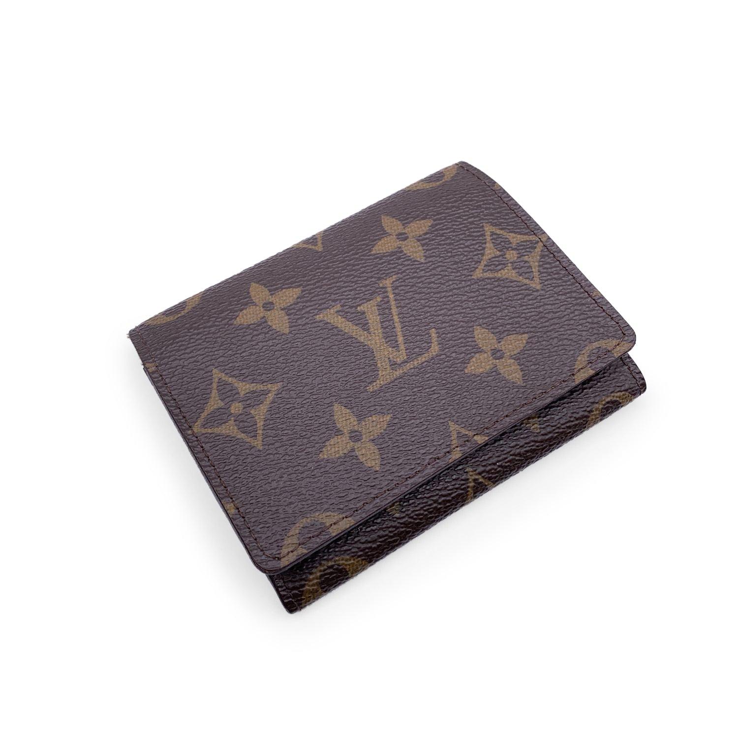 Louis Vuitton Business Card Holder. Crafted in brown monogram canvas. Tan leather lining. 3 open pockets. 'Louis Vuitton Paris - Made in Spain' embossed inside. Authenticity serial number embossed inside Details MATERIAL: Cloth COLOR: Brown MODEL:
