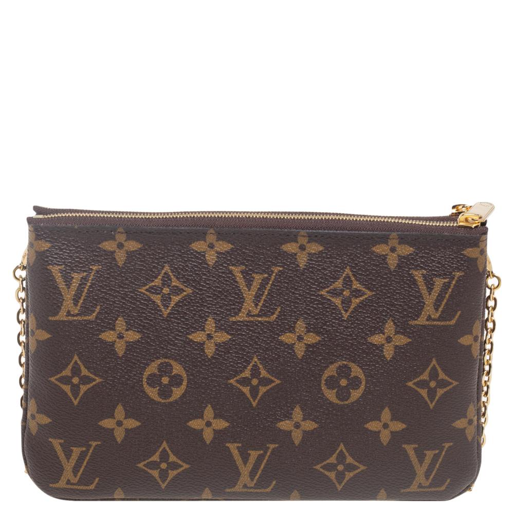 The exclusive Christmas Edition pochette from the house of Louis Vuitton is a stylish accessory to carry your basics. The pochette is crafted from signature monogram canvas and decorated with the LV mascot on the front. The twin zipper compartments