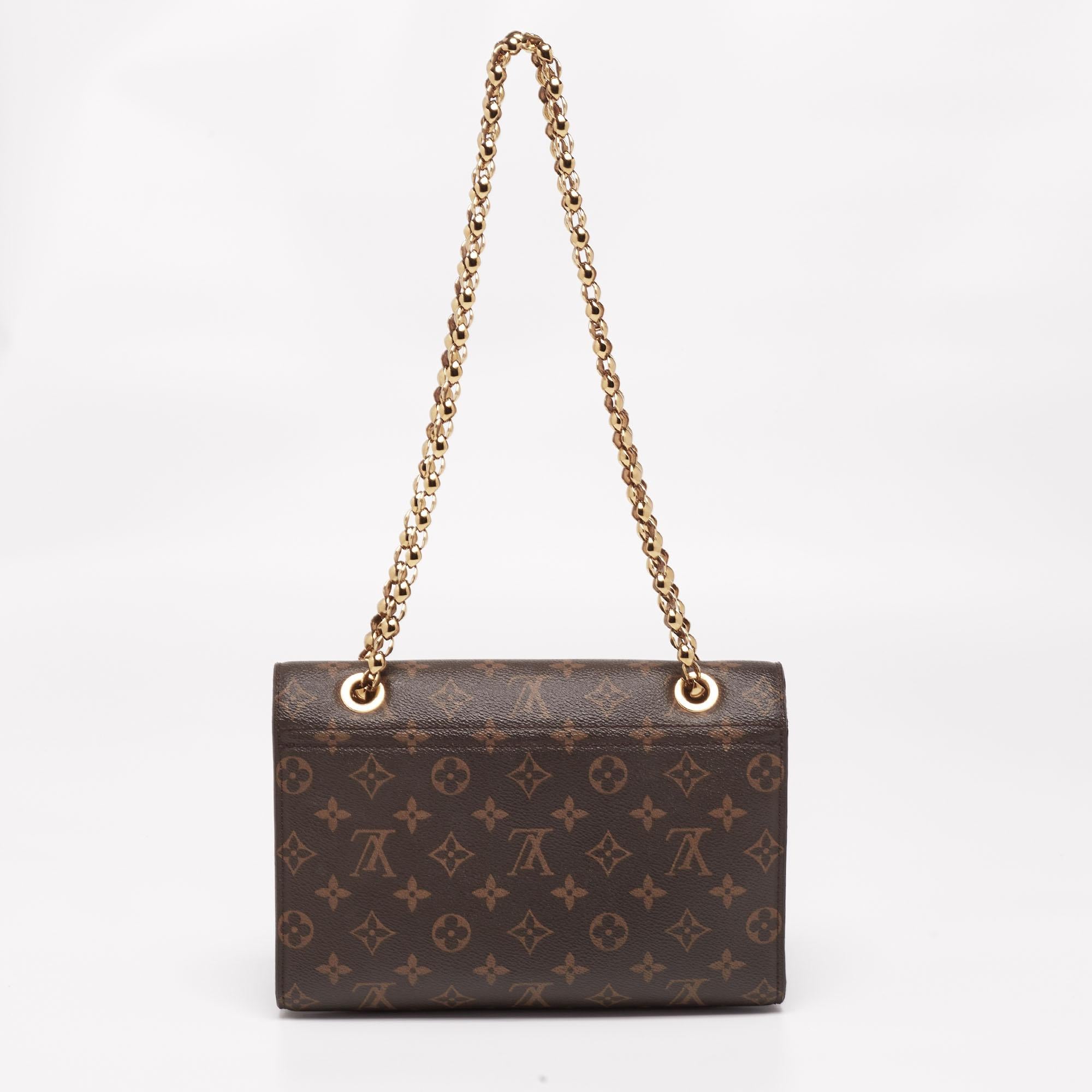 The Victoire bag pairs monogram canvas with smooth leather to give you a sophisticated day-to-evening accessory. The gold-tone closure is fixed on the front flap and the sliding chain strap helps you carry the bag easily. Large enough to fit your