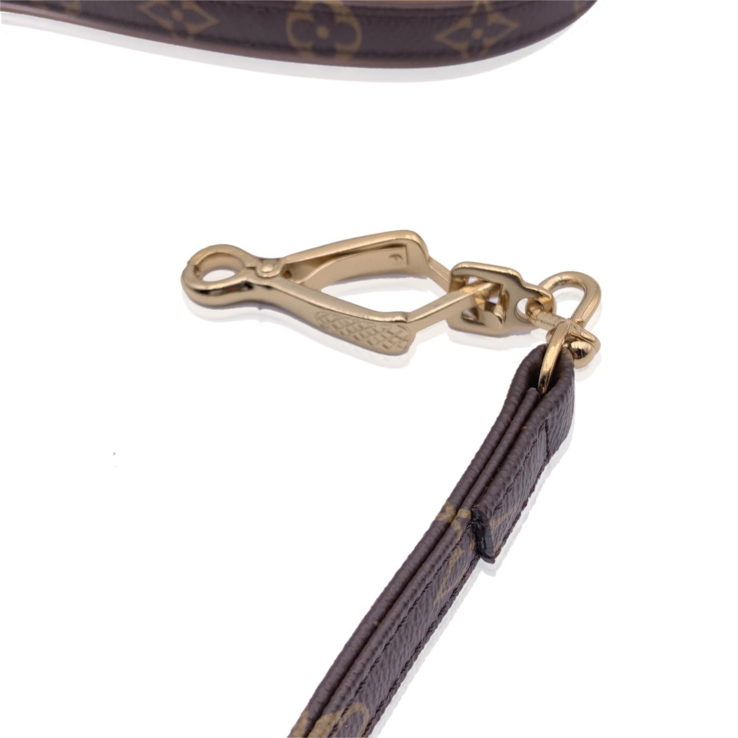 Louis Vuitton brown monogram canvas dog Baxter Leash MM. Natural cowhide leather trim. Gold metal hardware. For small or medium dogs. Total length: 41 inches - 104.2 cm. 'Louis Vuitton Paris' and 'Made in France' embossed on leather. Data code