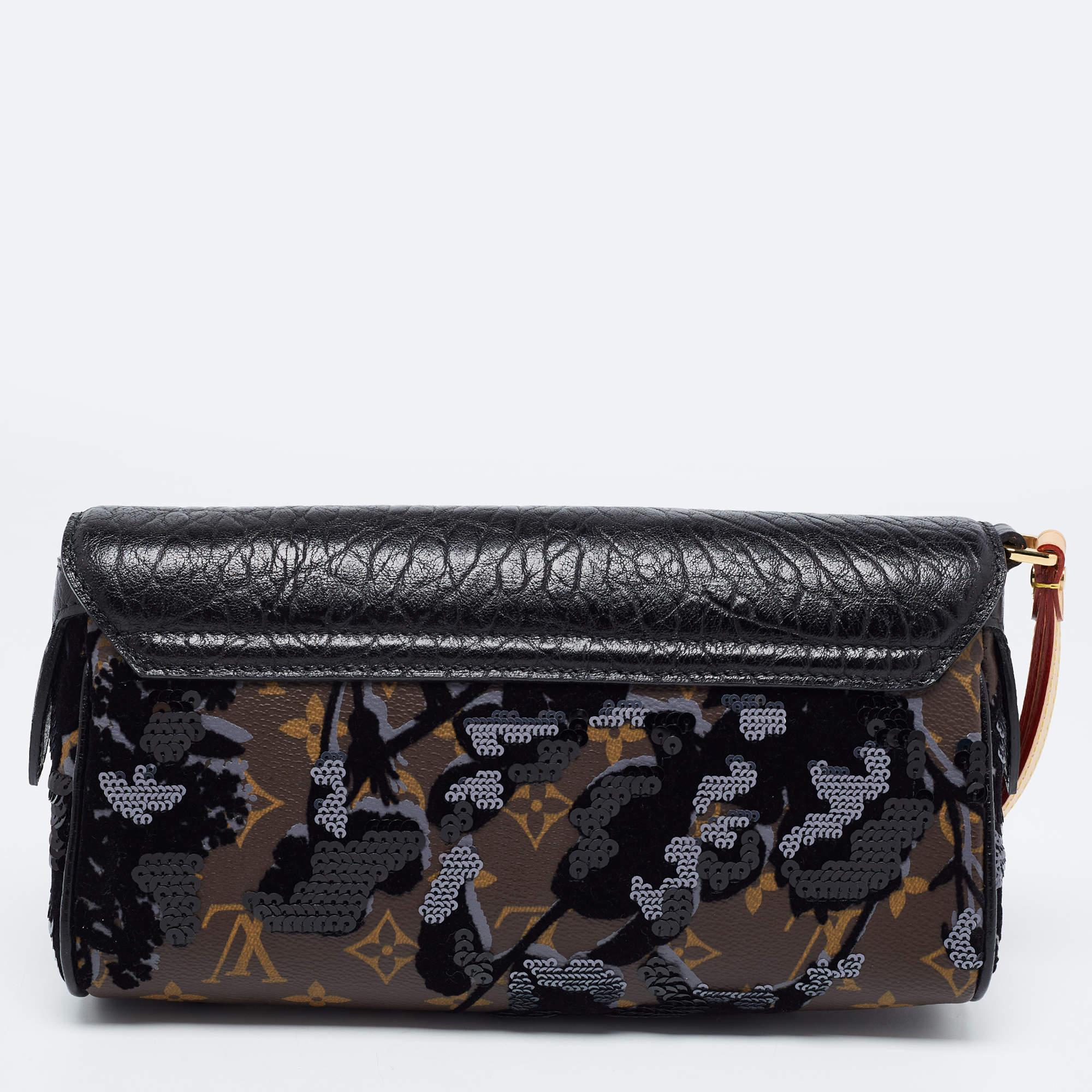 This Louis Vuitton Limited Edition Fleur de Jais Manege clutch is packed with luxury and utility. Crafted using Monogram canvas and leather, this Fleur de Jais Manege LV clutch will keep your little essentials safe. It features a wristlet on the