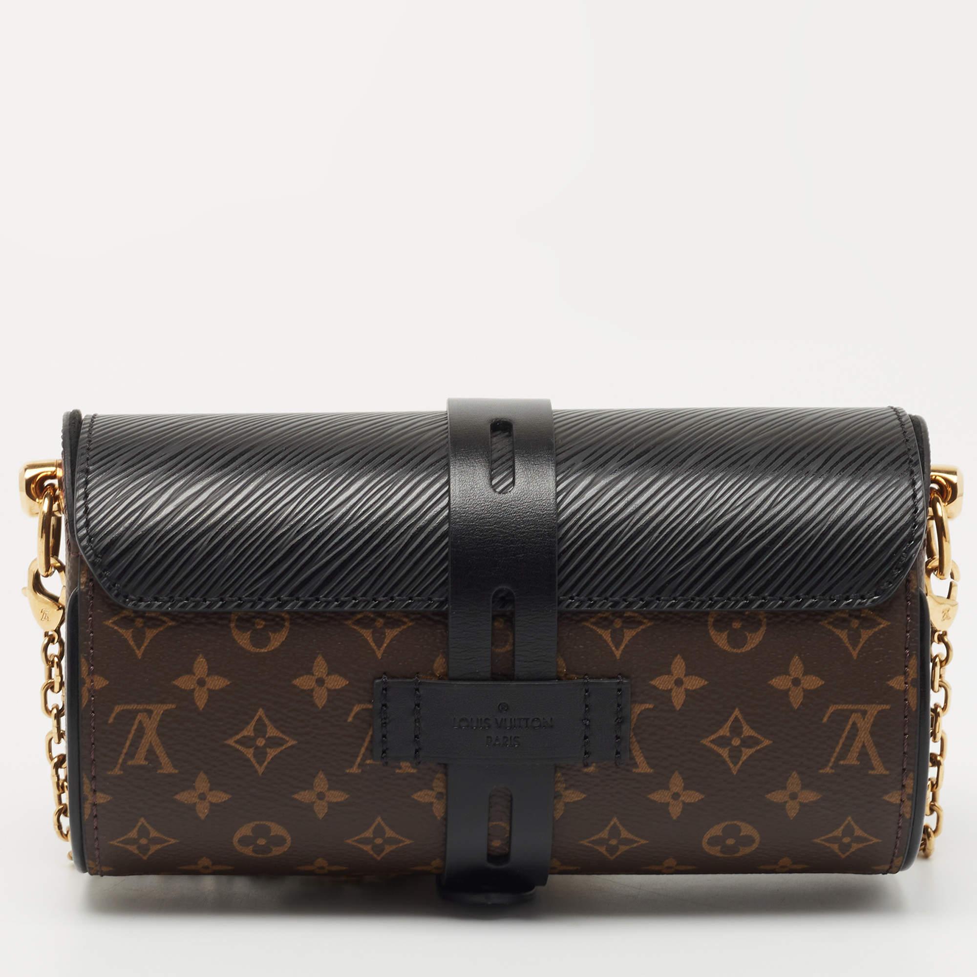 Louis Vuitton's glasses case bag is presented in Epi leather and Monogram canvas, the combination resulting in a luxurious look. Gold-tone hardware takes the appeal higher.

Includes: Padlock & Keys
