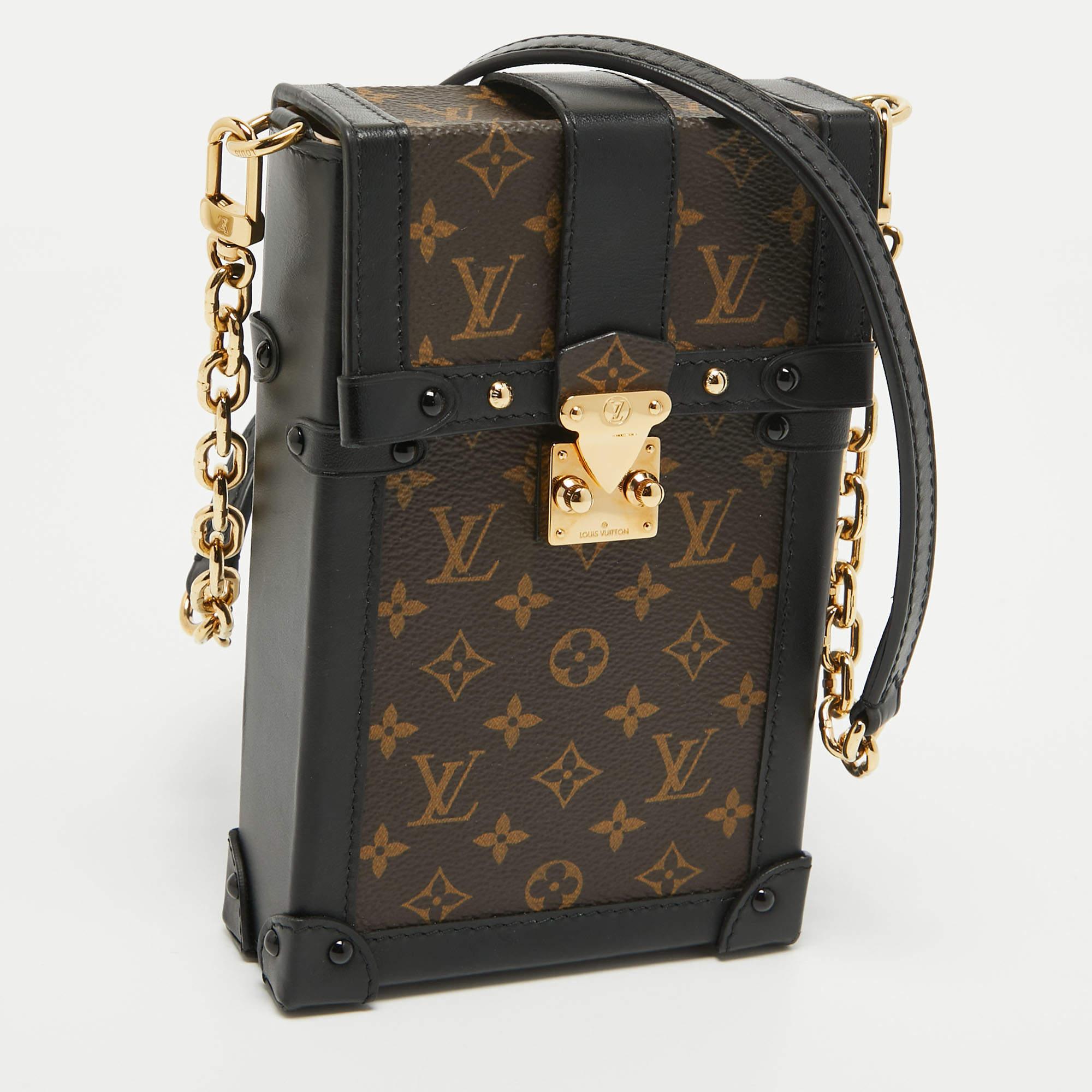 The Louis Vuitton Trunk Pochette is a luxurious accessory featuring the iconic LV monogram canvas and supple leather accents. Its vertical trunk-inspired design exudes sophistication, with a compact yet spacious interior, making it a stylish and