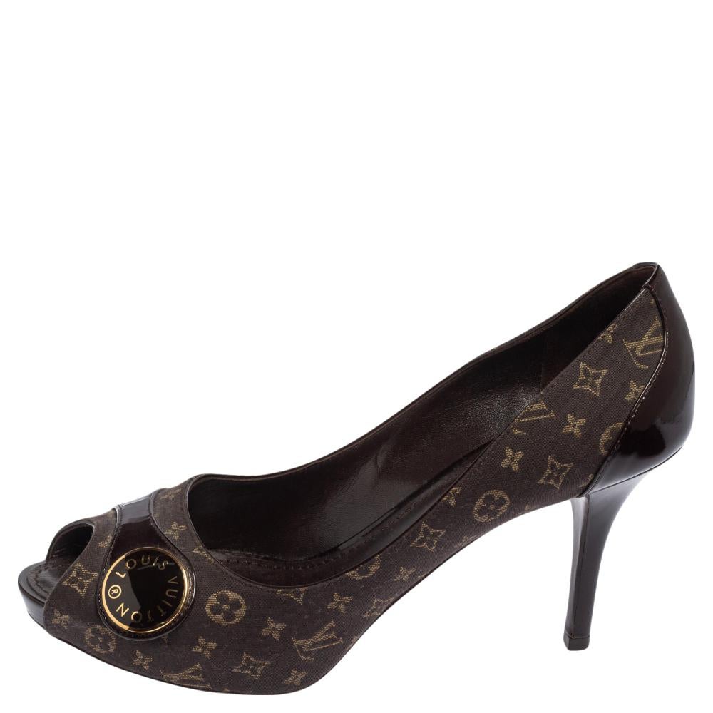 Simple, elegant, and versatile, Louis Vuitton's pumps exemplify the label's brilliant craftsmanship in shoemaking. Made from patent leather and monogram canvas in a brown shade, they feature buckles on the uppers accented by the brand's name. The