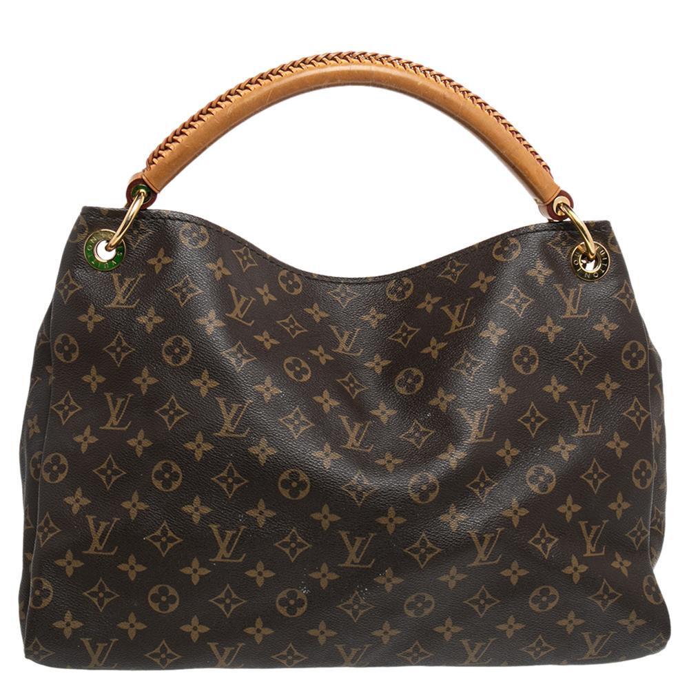 Flaunt this Louis Vuitton Artsy bag like a fashionista! Crafted from their signature Monogram canvas, this bag features an open top that reveals an Alcantara-lined interior, spacious enough to carry all your essentials. The bag is completed with a