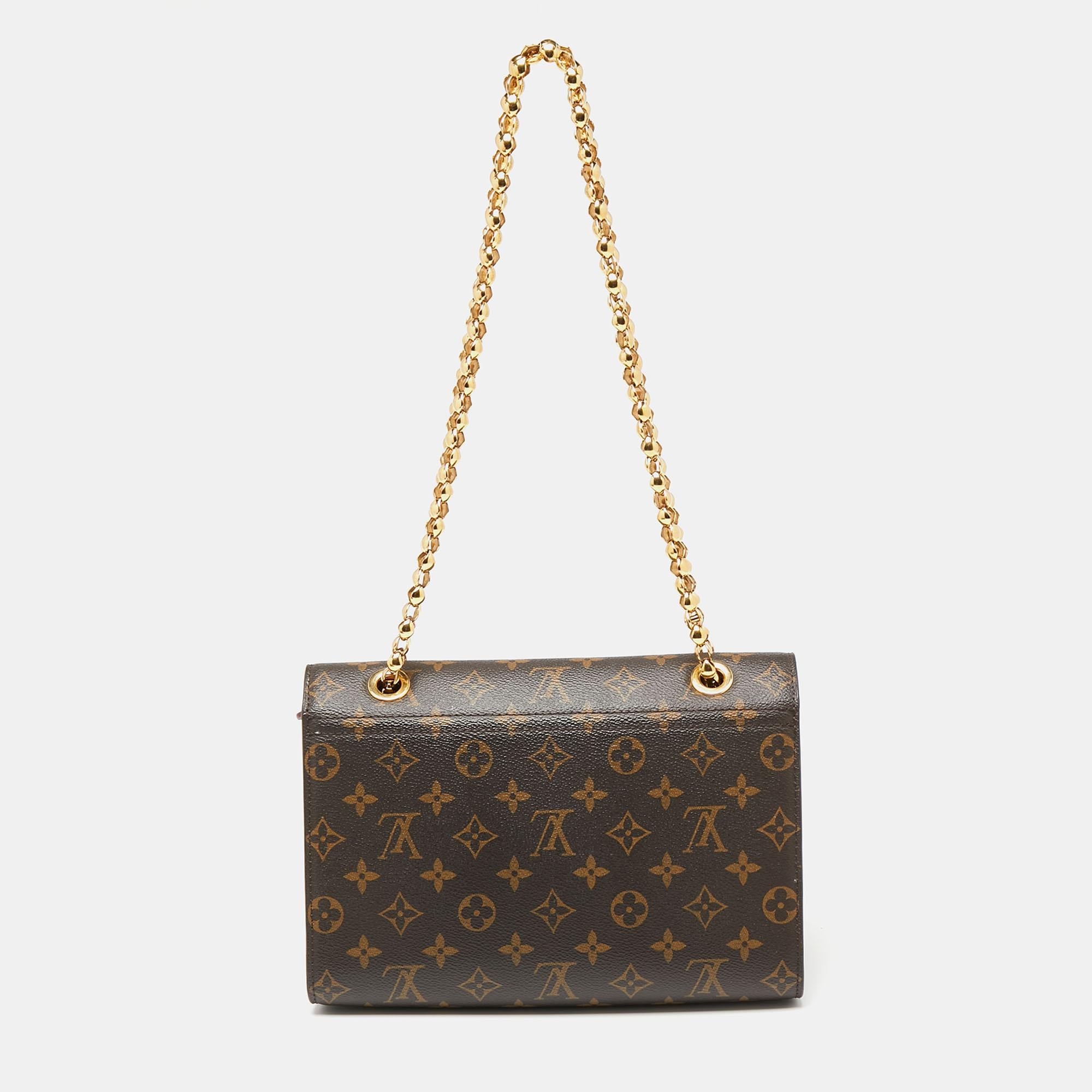 The Victoire bag pairs monogram canvas with smooth leather to give you a sophisticated day-to-evening accessory. The gold-tone closure is fixed on the front flap and the sliding chain strap helps you carry the bag easily. Large enough to fit your