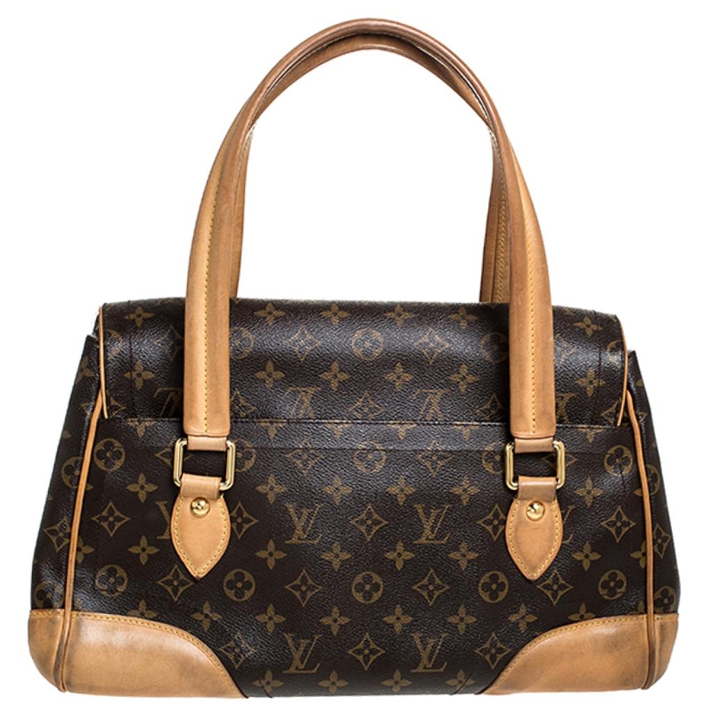 It is every woman's dream to own a Louis Vuitton handbag as appealing as this one. Crafted from their signature monogram canvas and leather, this bag features two top handles and a flap with a push lock. While the gold-tone hardware elevates its