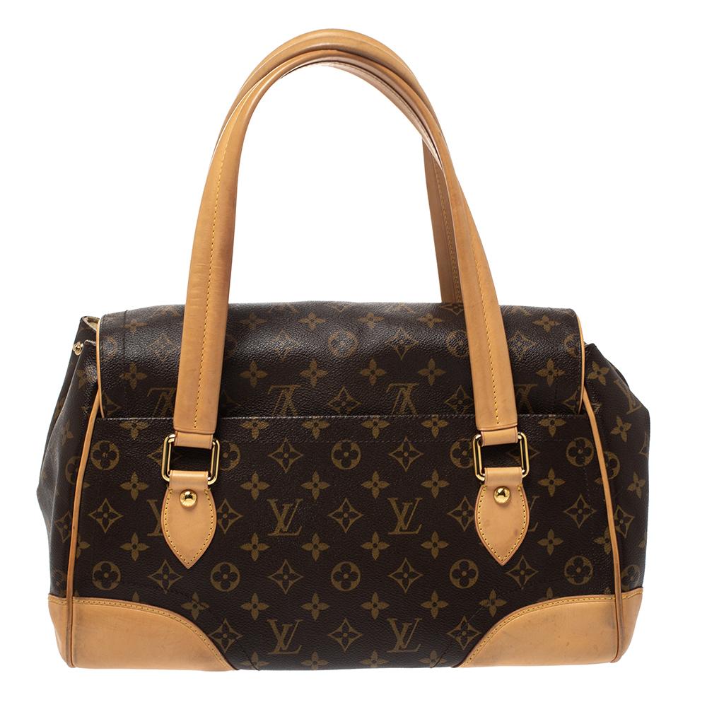It is every woman's dream to own a Louis Vuitton handbag as appealing as this one. Crafted from their signature monogram canvas and leather, this bag features two top handles and a flap with a push lock. While the gold-tone hardware elevates its