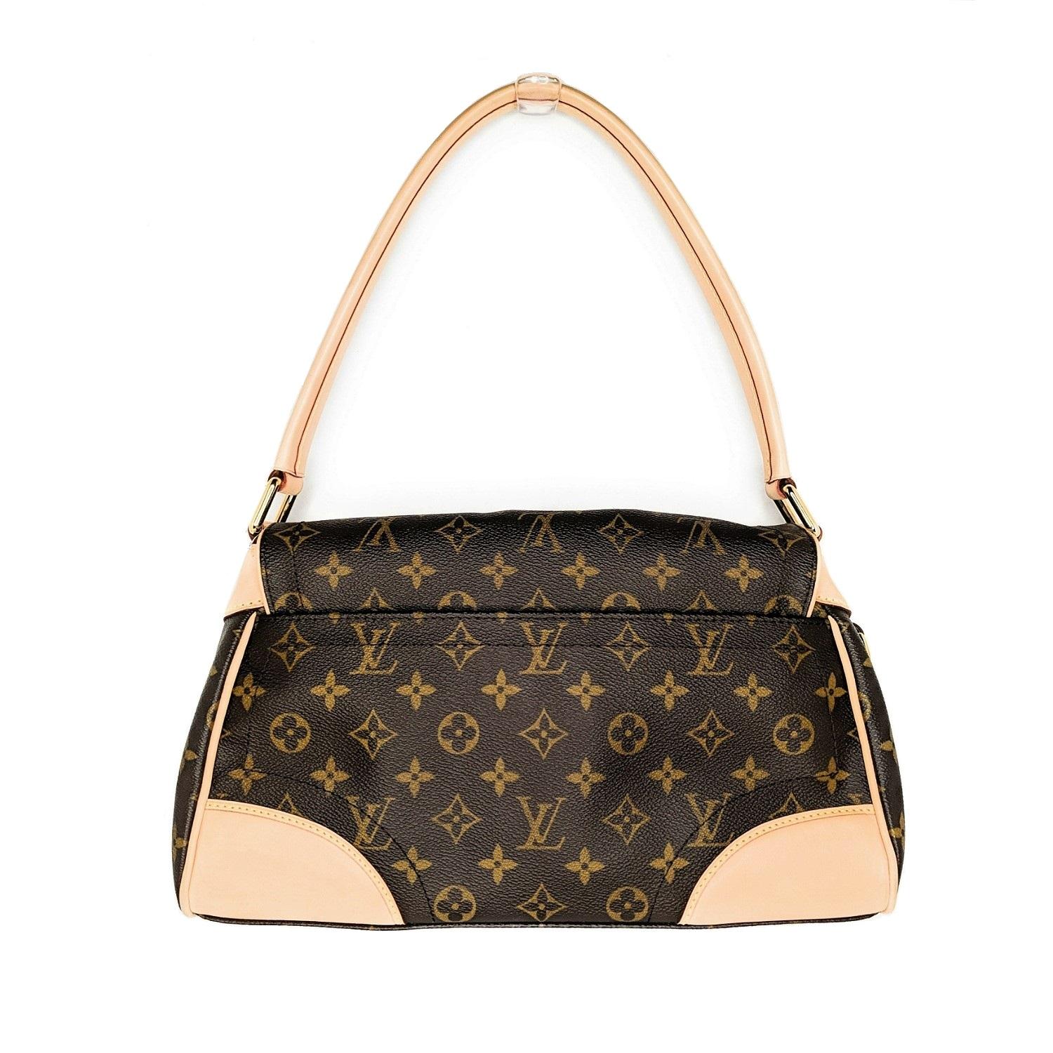 This chic shoulder bag is crafted of traditional Louis Vuitton monogram on toile canvas. The bag features a rear flat pocket, and vachetta cowhide leather trim, piping, and polished brass hardware. The crossover flap opens with a press lock to a