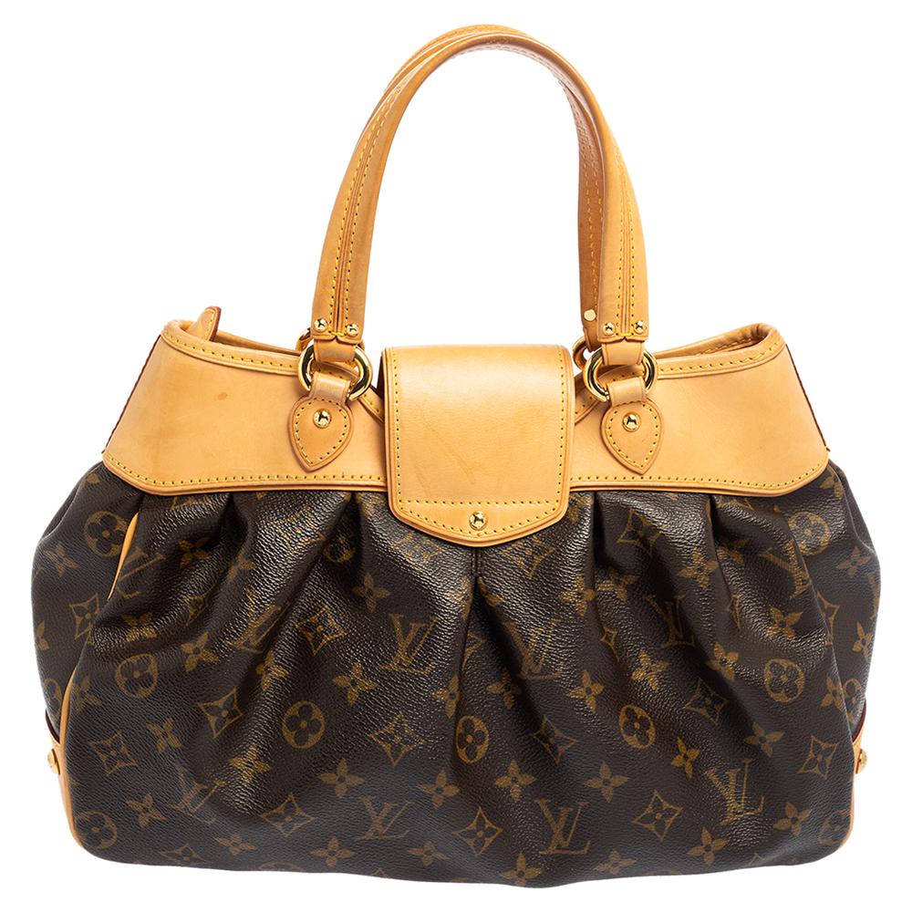 This elegant Boetie PM bag is designed with the brand's monogram canvas and detailed with leather. It features dual top handles, making it easy to carry. The front flap with a twist-lock opens to an interior lined with Alcantara. The bag is finished