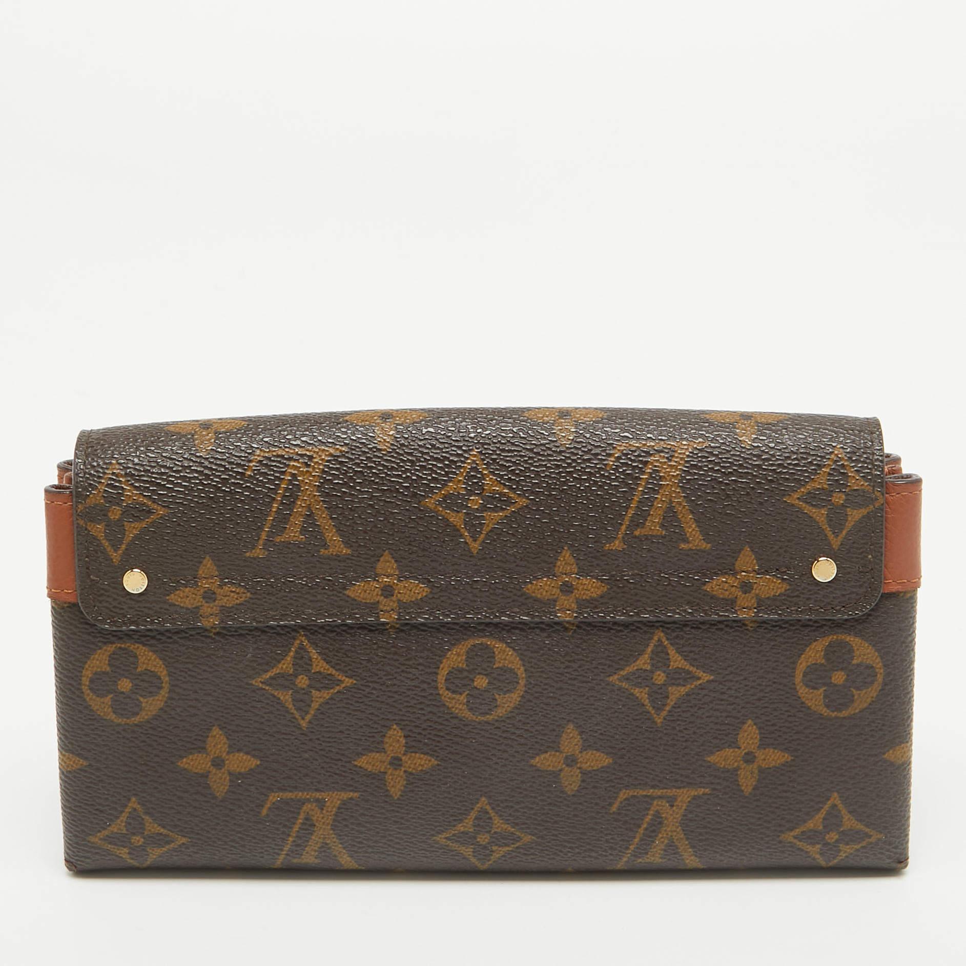 Made using signature Monogram canvas, this Elysee wallet from Louis Vuitton is a gorgeous creation. The flap with a metal lock closure opens to an interior housing multiple card slots, a zipped pocket, and open compartments.

