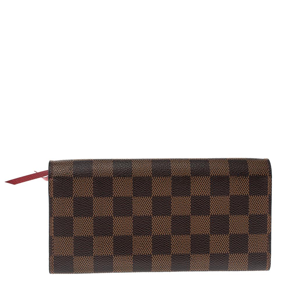 Crafted into an exquisite design, this Emilie wallet from Louis Vuitton is an important accessory. Store your essentials effortlessly in this sturdy Monogram canvas wallet. A subtle yet catchy brown shade characterizes it. It has a front flap,