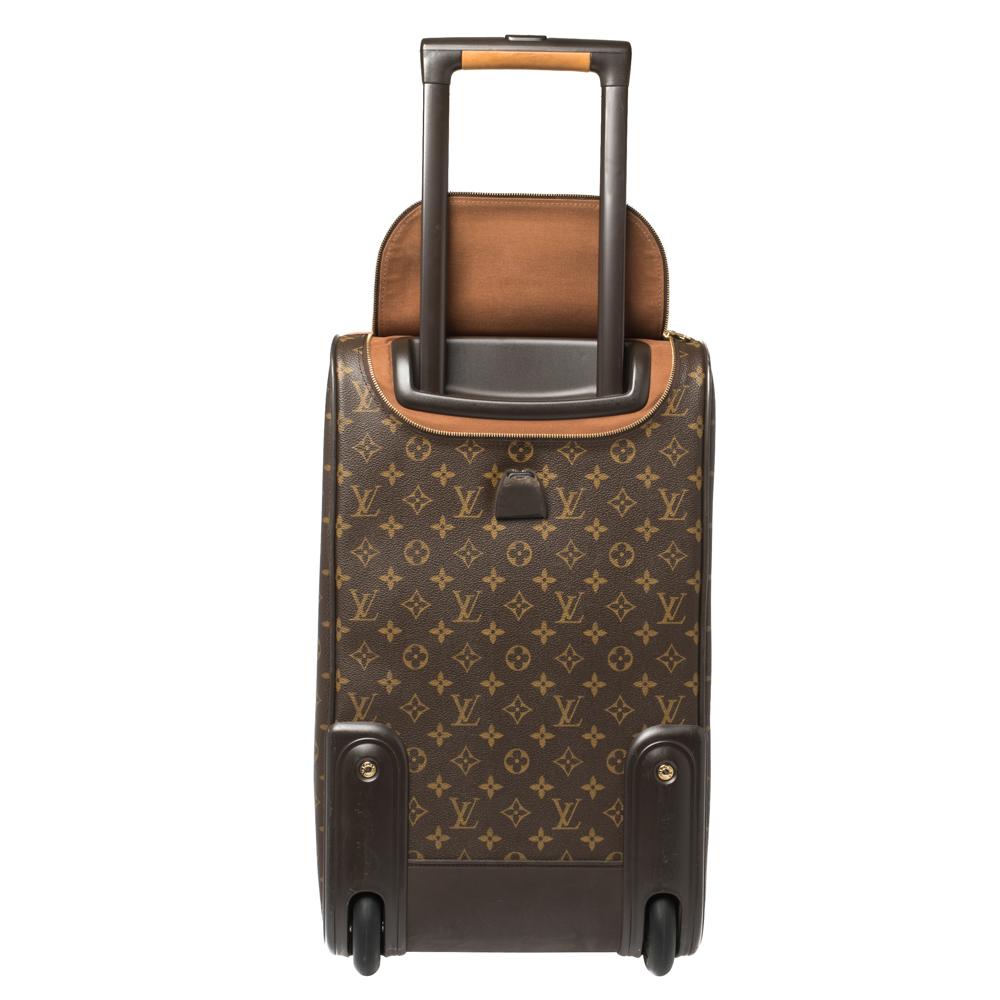 Featuring a chic, yet luxurious style, this Louis Vuitton luggage bag is distinctive. Coated in traditional Monogram canvas and leather, the bag features dual-rolled handles with a buckle fastening clasp at the top. The trolly bag bears two wheels