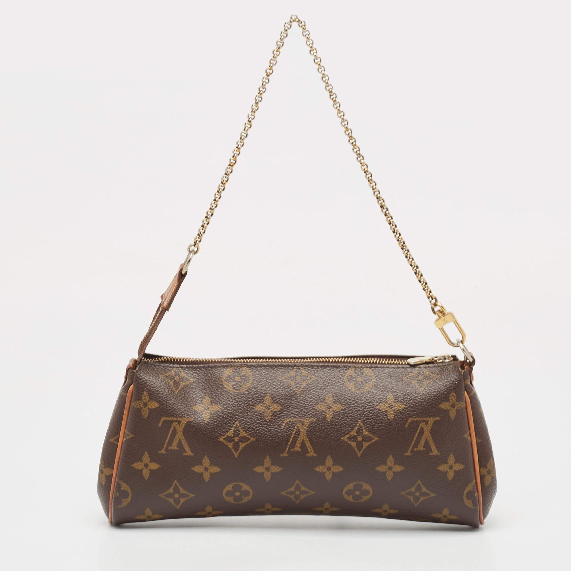Crafted from Monogram canvas, this Eva Pochette bag is an adored creation by Louis Vuitton. The bag features a well-sized canvas interior that is secured by a gold-tone zipper. It comes with a chain and a leather strap.

Includes: invoice, Original