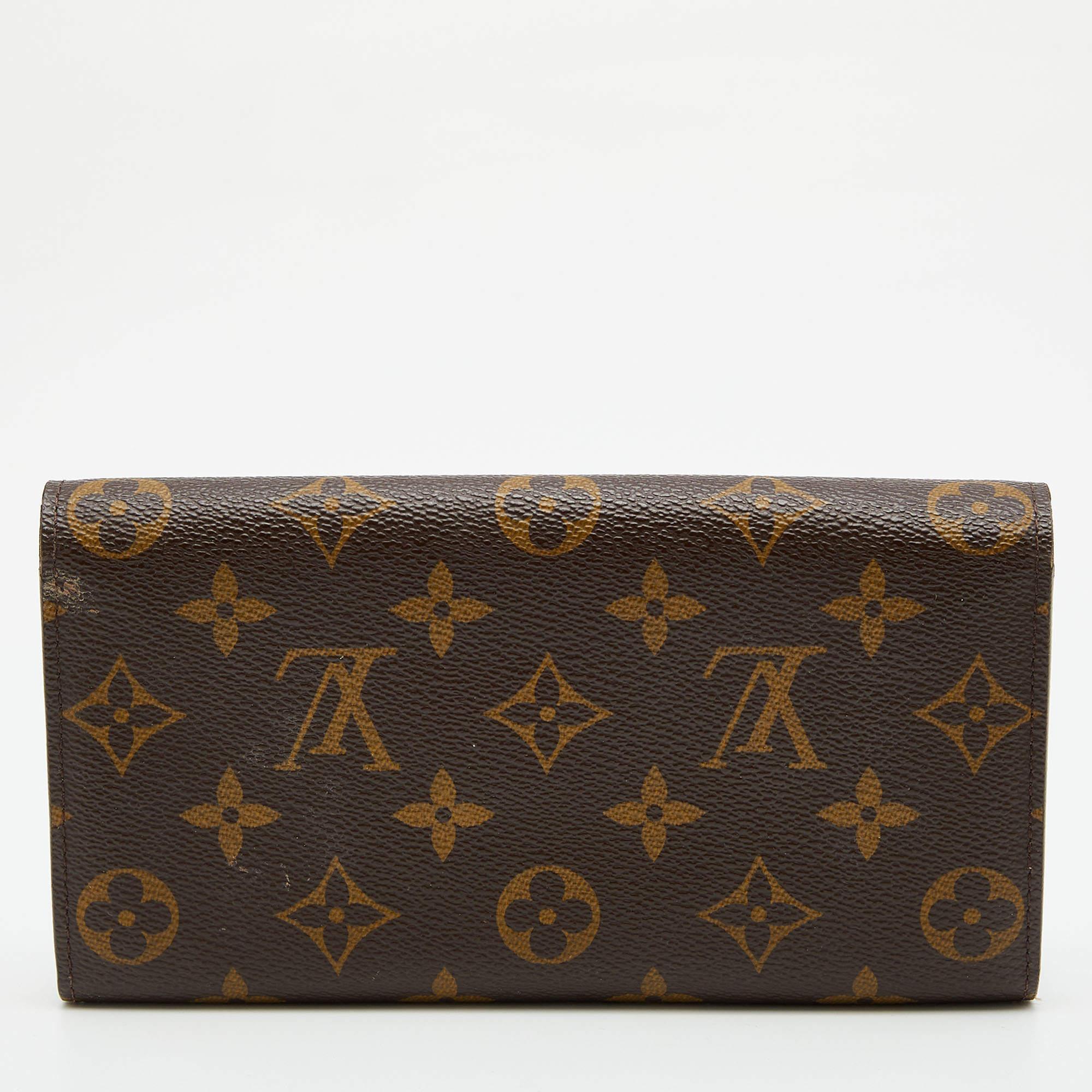 Crafted from the signature Monogram canvas, this Louis Vuitton Sarah wallet is a valuable accessory. Its compartmentalized interior is perfect for storing your monetary essentials, and the gold-tone accents add to the charm of the wallet.

