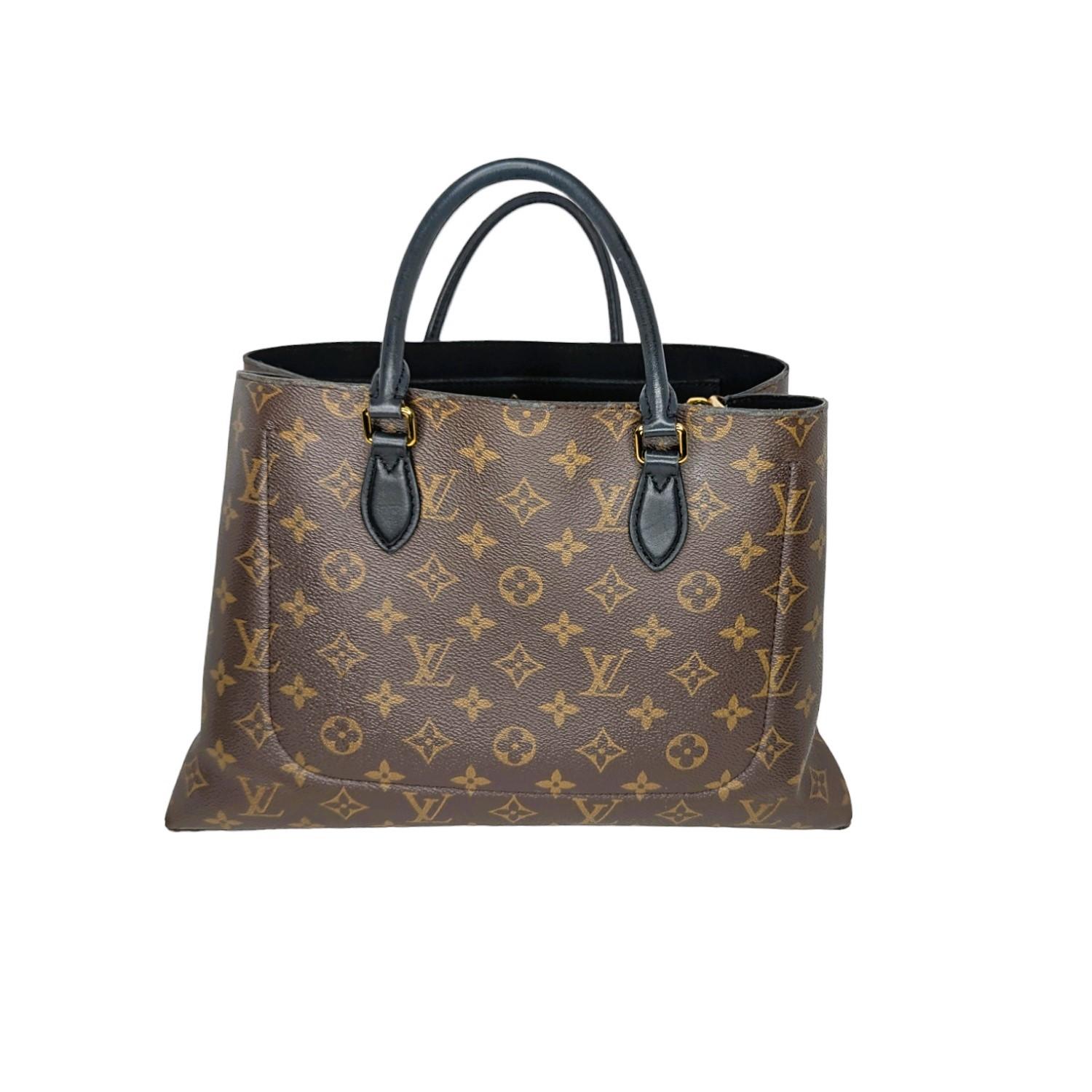 From the 2020 collection by designer Nicolas Ghesquiere. This beautiful tote is crafted of Monogram coated canvas, sleek leather handles, and a stunning Monogram Flower padlock. The roomy interior includes a zippered pocket, two flat pockets, and