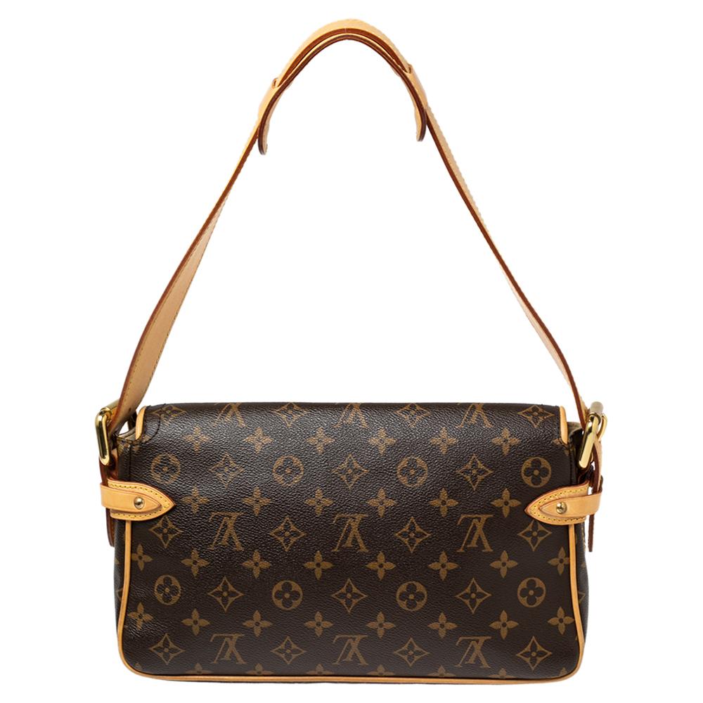 This Hudson PM by Louis Vuitton is a handbag you can carry for years to come. It features an easy-to-match monogram canvas exterior with leather trims, dual push-button front pockets, flap front buckle closure, and a single leather shoulder strap.