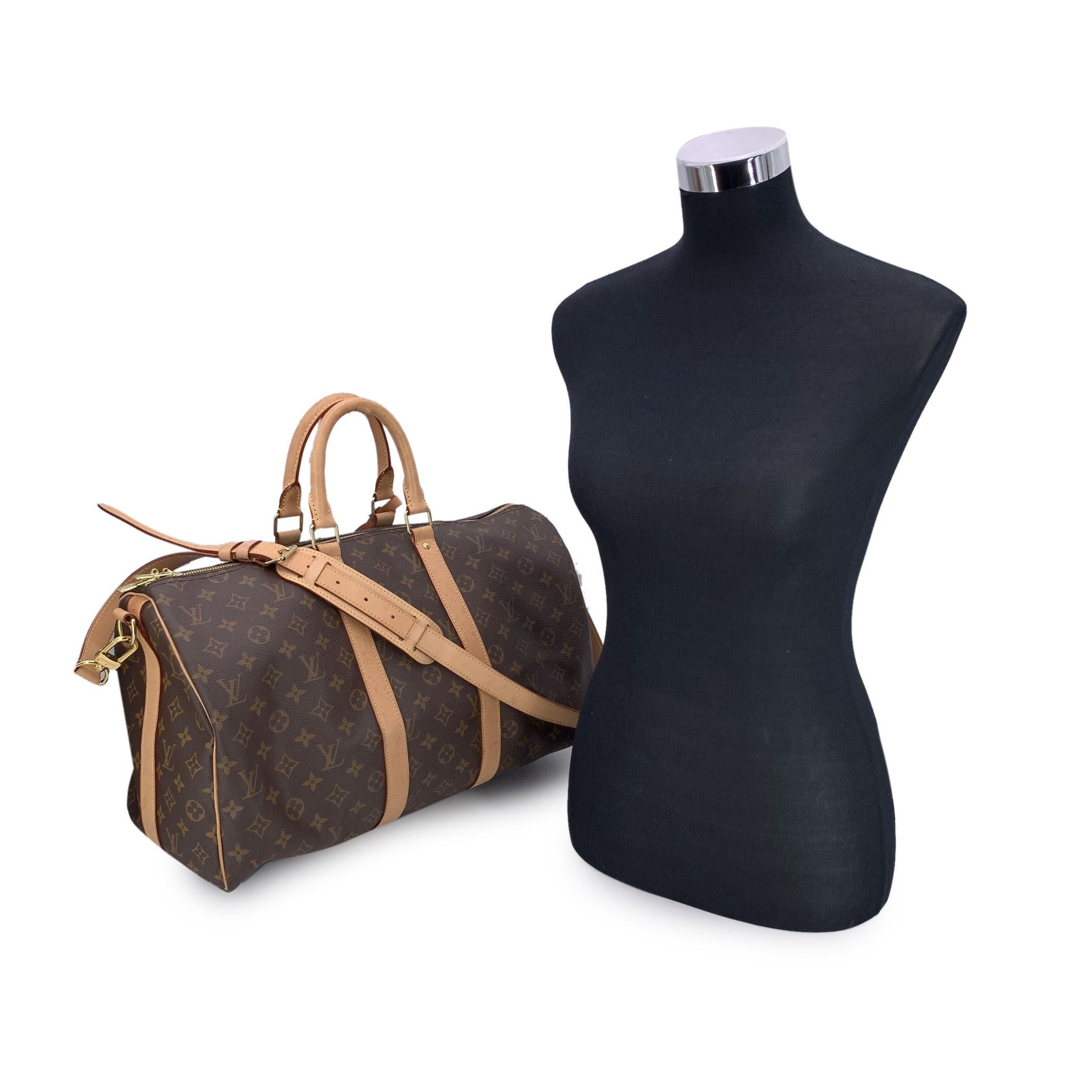 This beautiful Bag will come with a Certificate of Authenticity. The certificate will be provided at no further cost Step into the world of timeless luxury with the Louis Vuitton Monogram Canvas vintage 'Keepall 45 Bandouliere' Travel Bag. A classic
