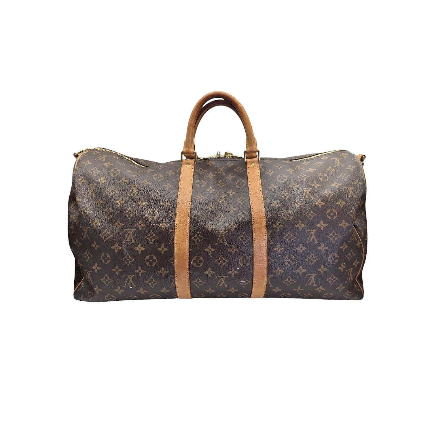 Indulge in the luxury of this exquisite Louis Vuitton Monogram Keepall Bandouliere 55. Crafted with the iconic monogram coated canvas and finished with natural cowhide trim, this bag exudes elegance and sophistication. The spacious interior and