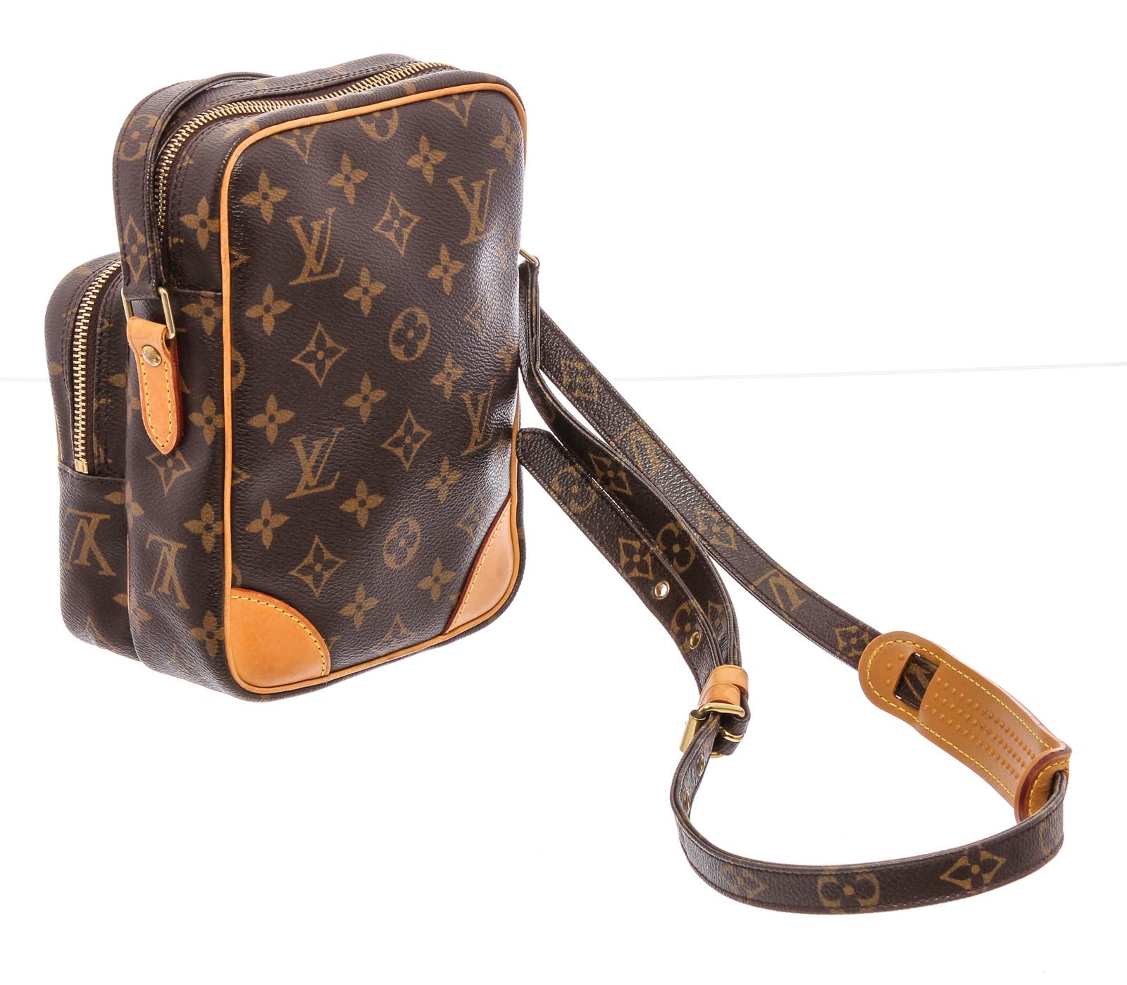 Brown and tan monogram coated canvas Louis Vuitton Amazone bag with brass hardware, tan vachetta leather trim, flat shoulder strap, exterior zip pocket, brown leather lining and zip closure at top. 

21525MSC MLR
