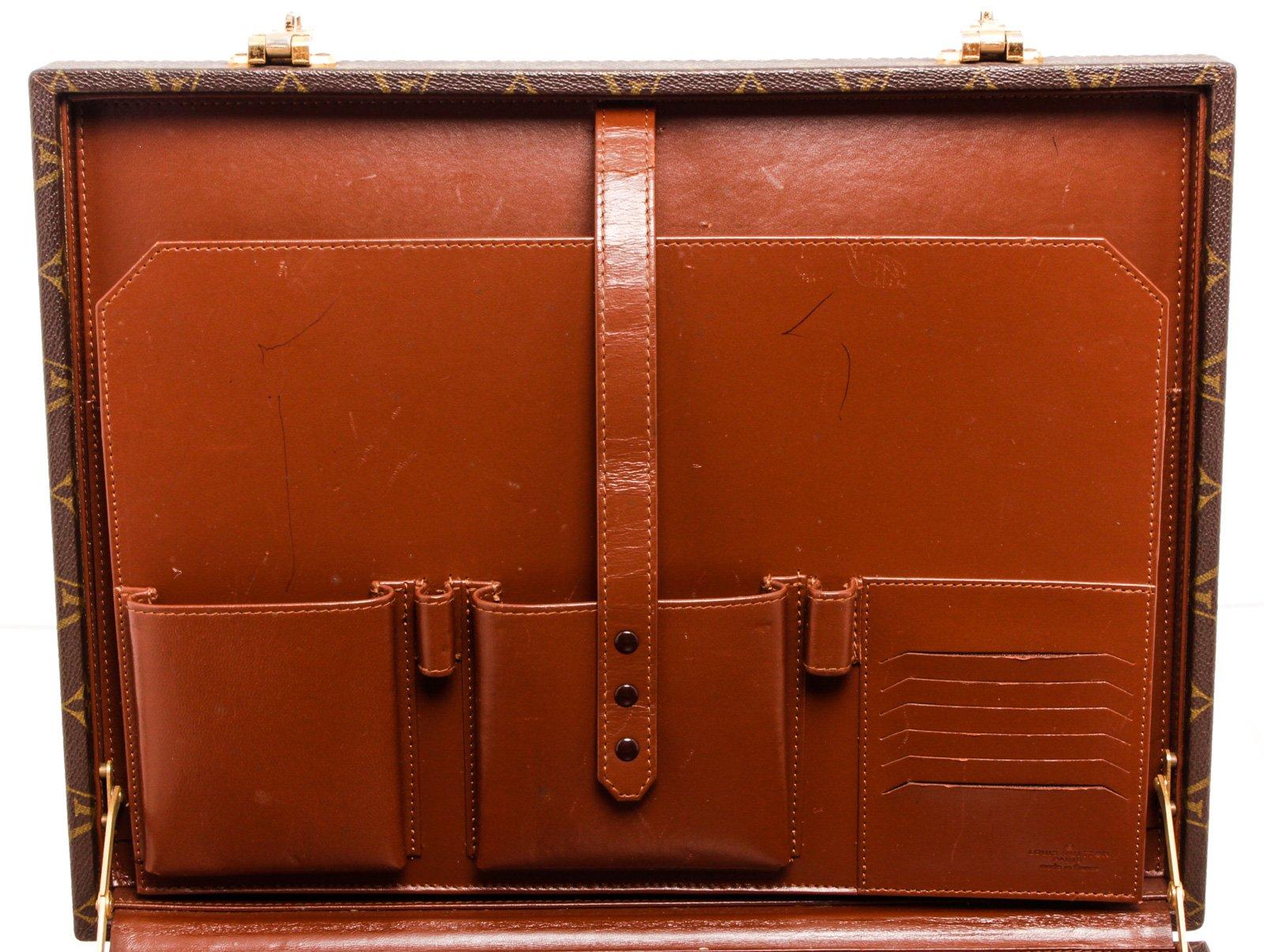 Louis Vuitton brown Monogram coated canvas President Briefcase with gold-tone hardware, brown leather interior, large back slip pocket, dual slip pockets, dual pen slots, and 6 card slots, push-lock closure.

25287MSC