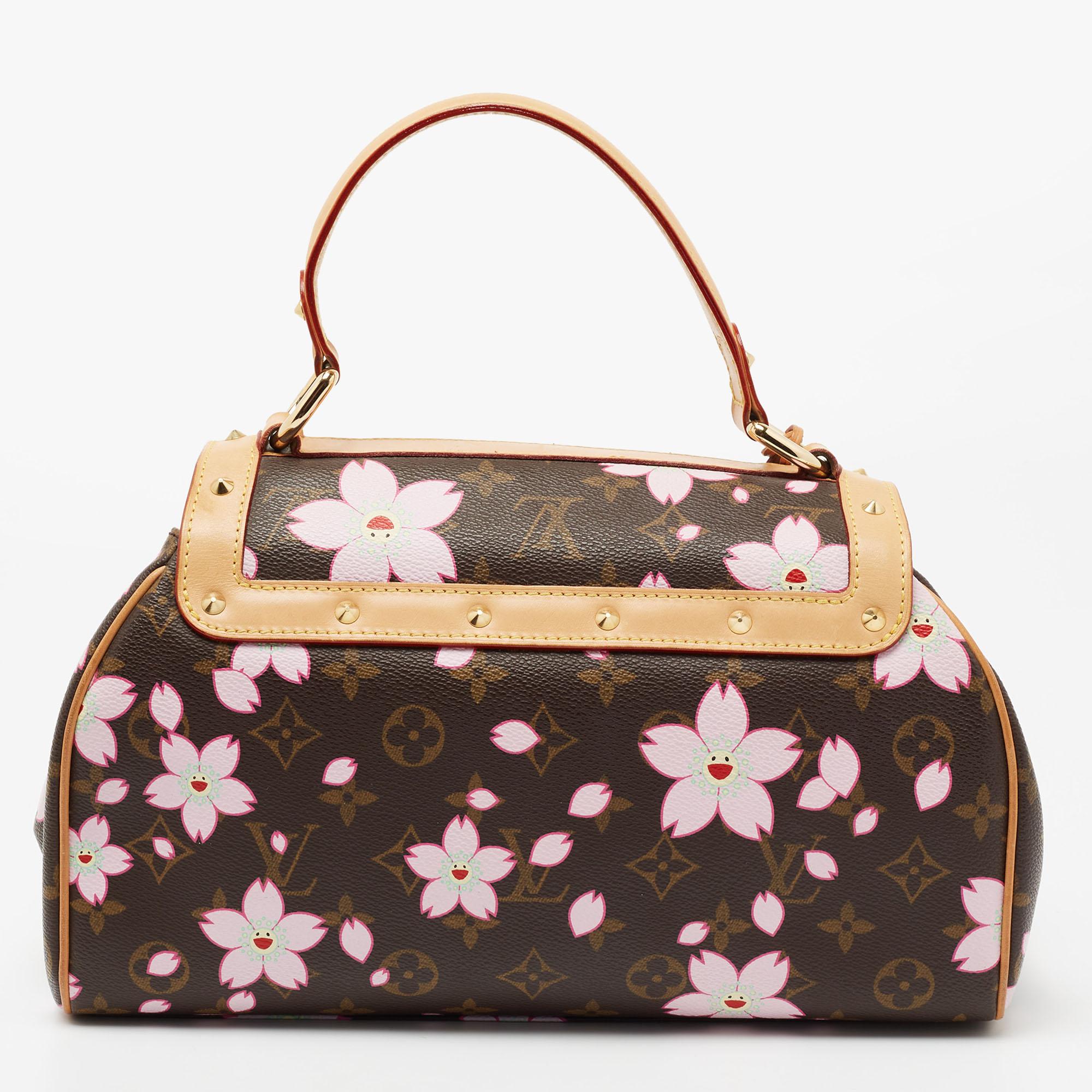 This limited edition Louis Vuitton Sac Retro bag was introduced in the Spring/Summer 2003 collection. The signature Monogram canvas got a cheerful update with the cherry blossoms designed by none other than Takashi Murakami. The bag is adorned with