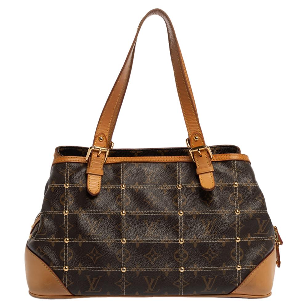 Limited edition bags are a closet's must-have. Made in France, this Riveting bag by Louis Vuitton has been crafted from signature monogram coated canvas and leather. The brown bag features dual top handles and flaunts gold-tone buckles and zip