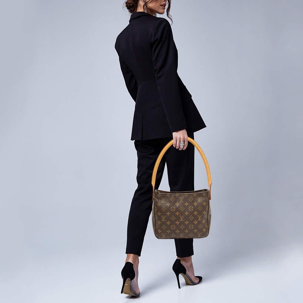 The Classic Looping bag from Louis Vuitton is an elegant way to stow your essentials. Crafted from a monogram canvas body this bag features a top zip closure and fitted with a single rolled top handle. The spacious Alcantara lined interior of this