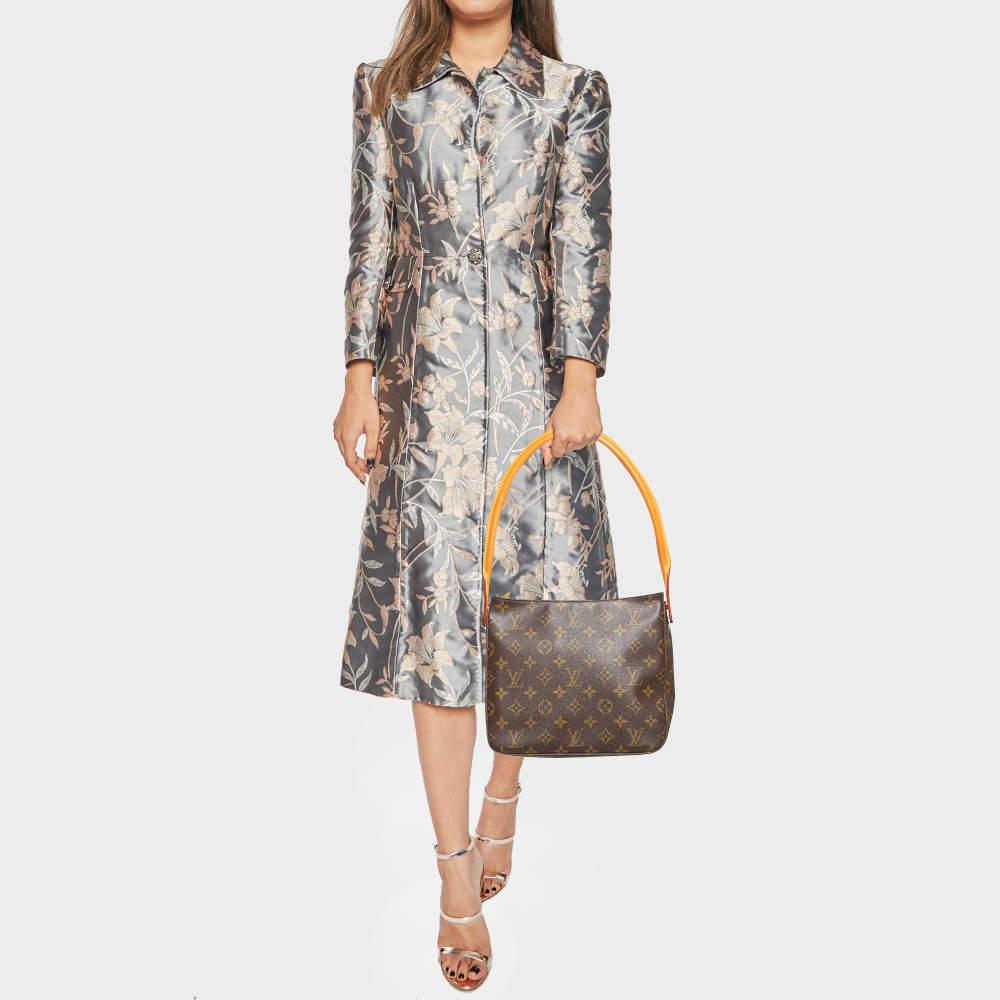 The Classic Looping bag from Louis Vuitton is an elegant way to stow your essentials. Crafted from a Monogram canvas body this bag features a top zip closure and is fitted with a single rolled top handle. The spacious Alcantara lined interior of
