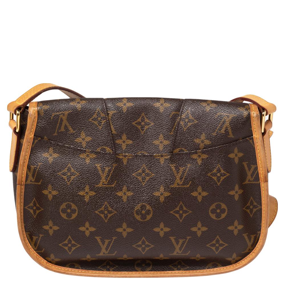 A messenger bag like this stylish yet functional Menilmontant PM from Louis Vuitton is a closet must-have. This bag is crafted from Louis Vuitton's iconic monogram canvas. The bag features leather trims, a flap front closure, an adjustable shoulder