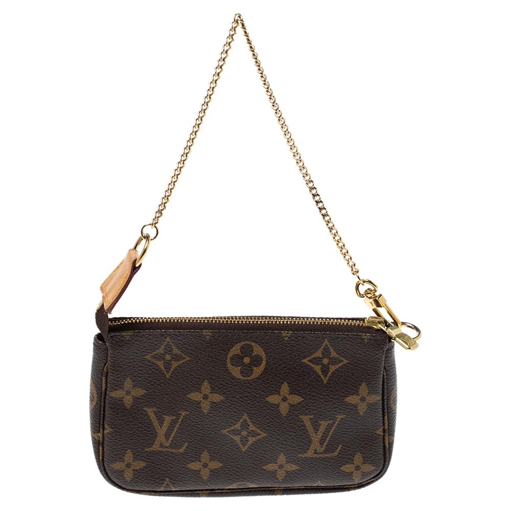 This stylish Louis Vuitton Mini Pochette Accessoires lends a contemporary yet feminine touch to your everyday look. This compact bag in Monogram canvas can be attached to other bags or simply carried on its own. The gold-tone chain strap is ideal