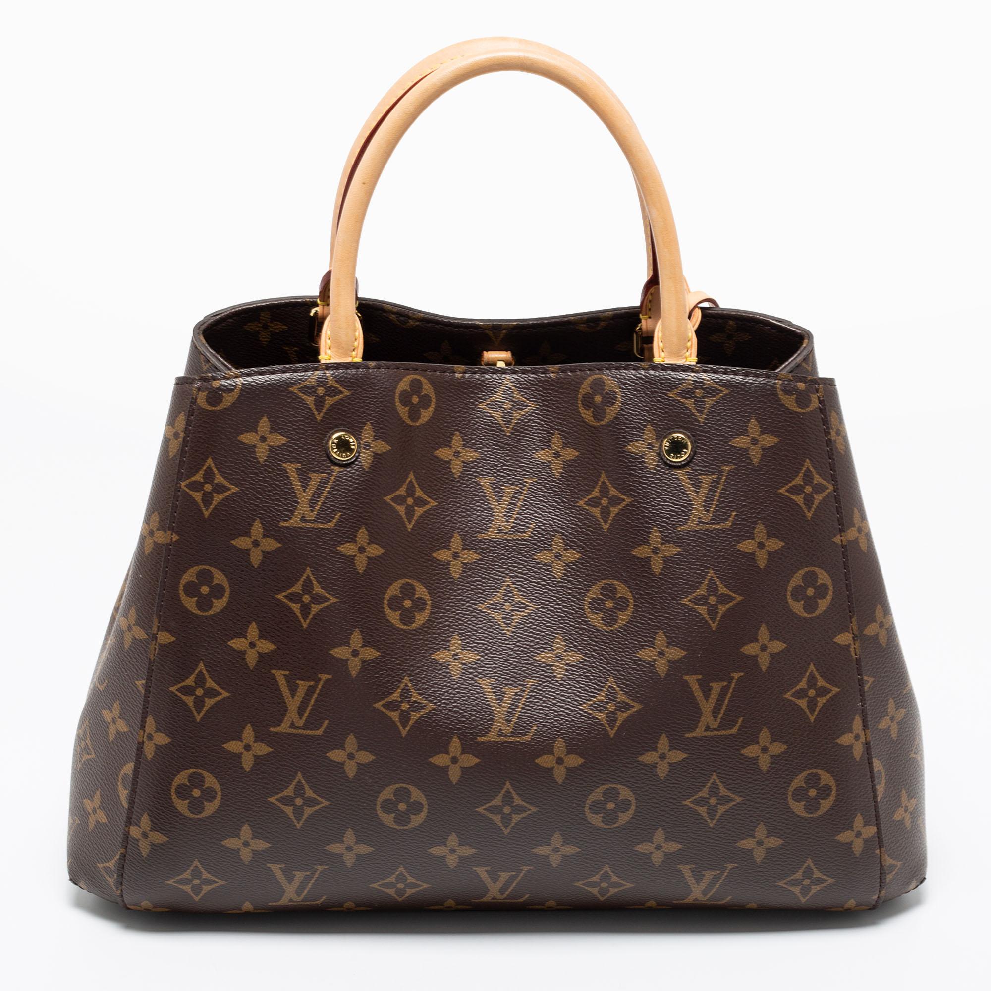 This Montaigne MM bag from Louis Vuitton perfectly balances appeal and function. Crafted from Monogram canvas, it has two rolled handles, a bag strap, gold-tone hardware, and a spacious interior that is divided by a zip compartment.

Includes: