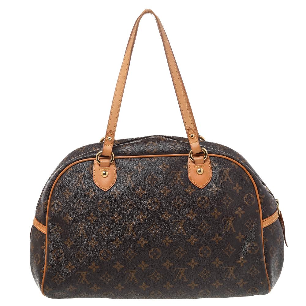Fashionable and handy, this Montorgueil bag by Louis Vuitton will make a great addition to your bag collection. The bag has been crafted from signature Monogram canvas and features dual leather handles. It has a top zipper that opens up to a