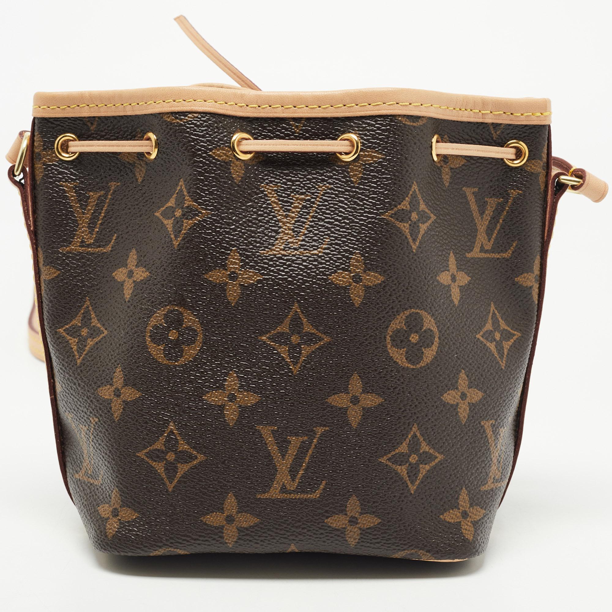 This Nano Neo bag brings forth Louis Vuitton's expertise in creating handbags. Crafted from Monogram canvas, the bag comes with a leather shoulder strap. It is fastened by a drawstring closure and lined with canvas.

Includes: Original Dustbag