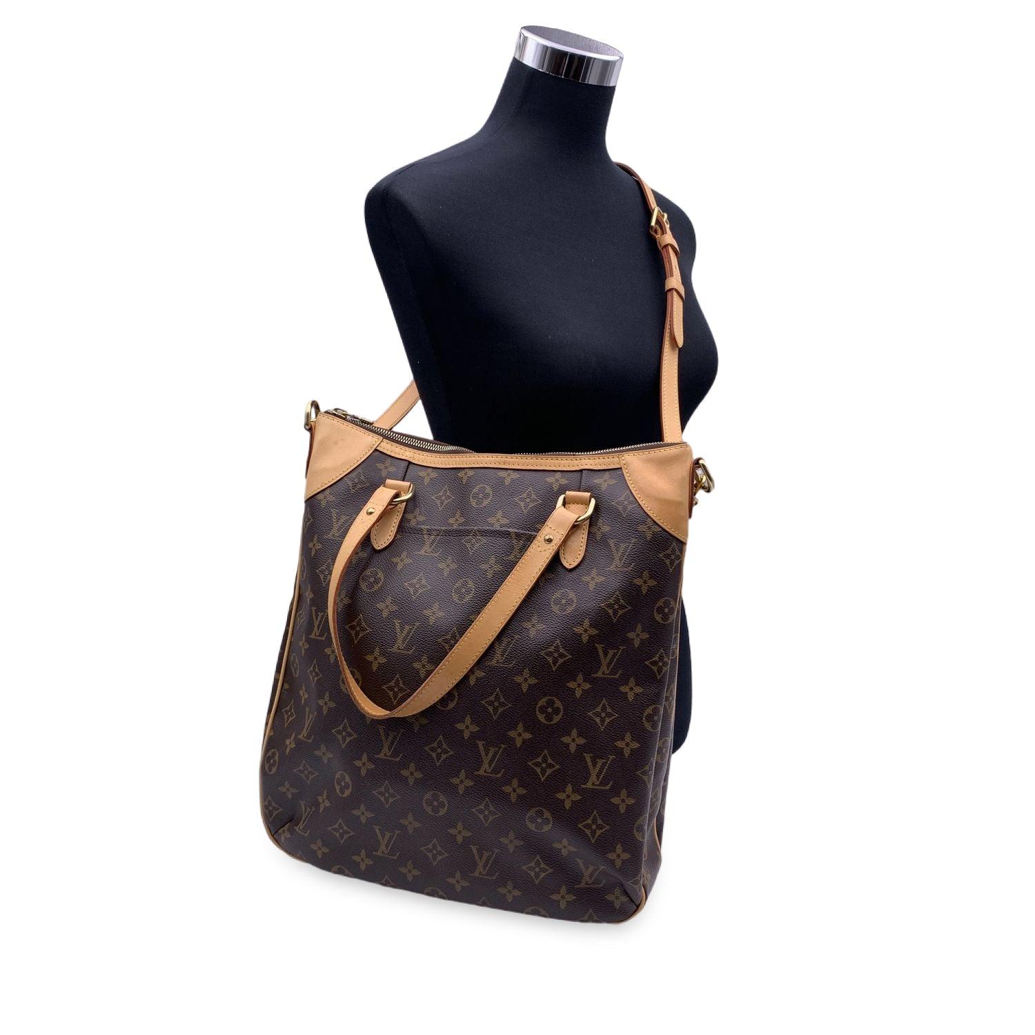 LOUIS VUITTON 'ODEON GM' Tote shoulder bag. Designed with timeless LV monogram canvas and accented with tan leather and gold-tone hardware. Zipper top closure. Features double handles and removable and adjustable shoulder strap. Brown canvas lining.
