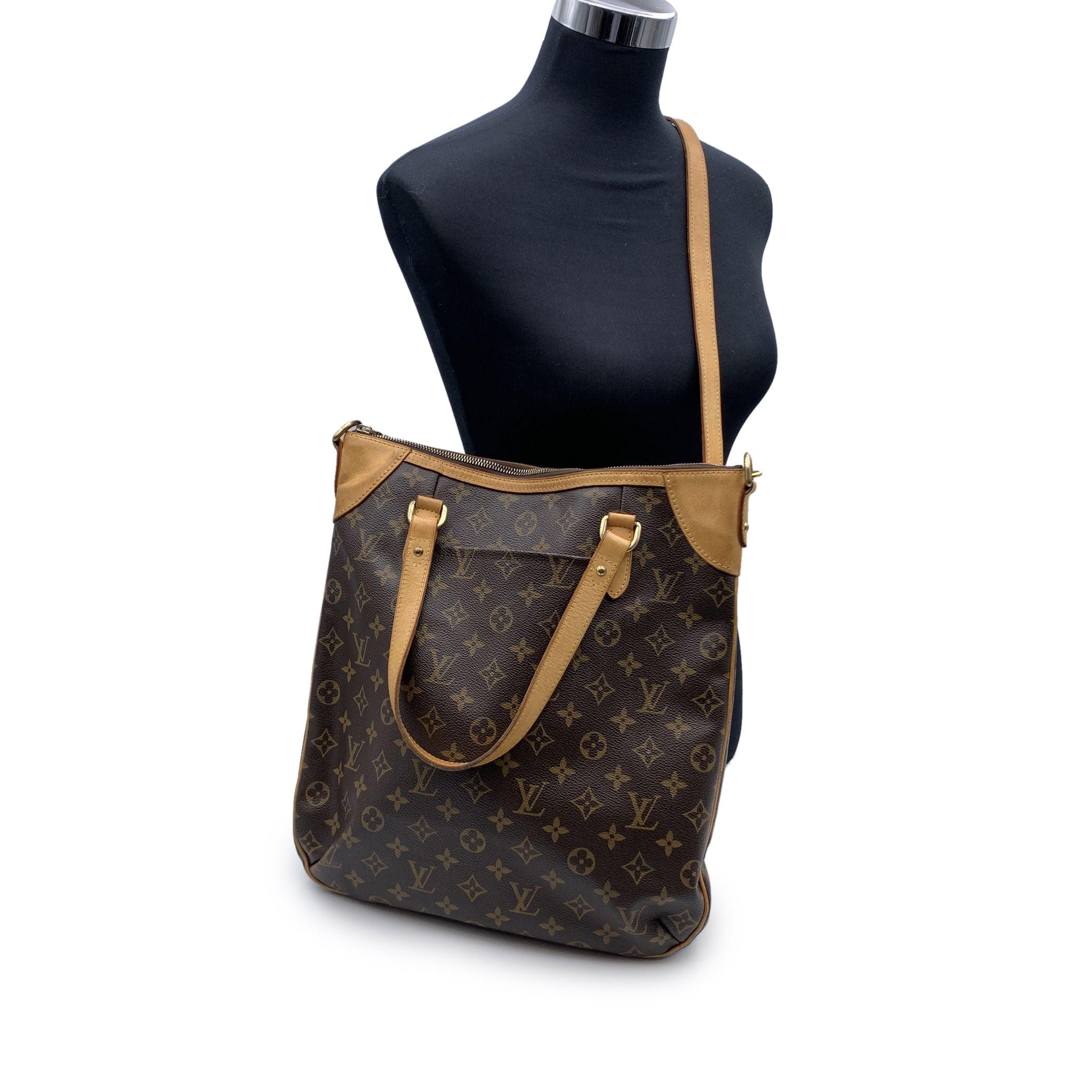LOUIS VUITTON 'ODEON GM' Tote shoulder bag. Designed with timeless LV monogram canvas and accented with tan leather and gold-tone hardware. Zipper top closure. Features double handles and removable and adjustable shoulder strap. Brown canvas lining.