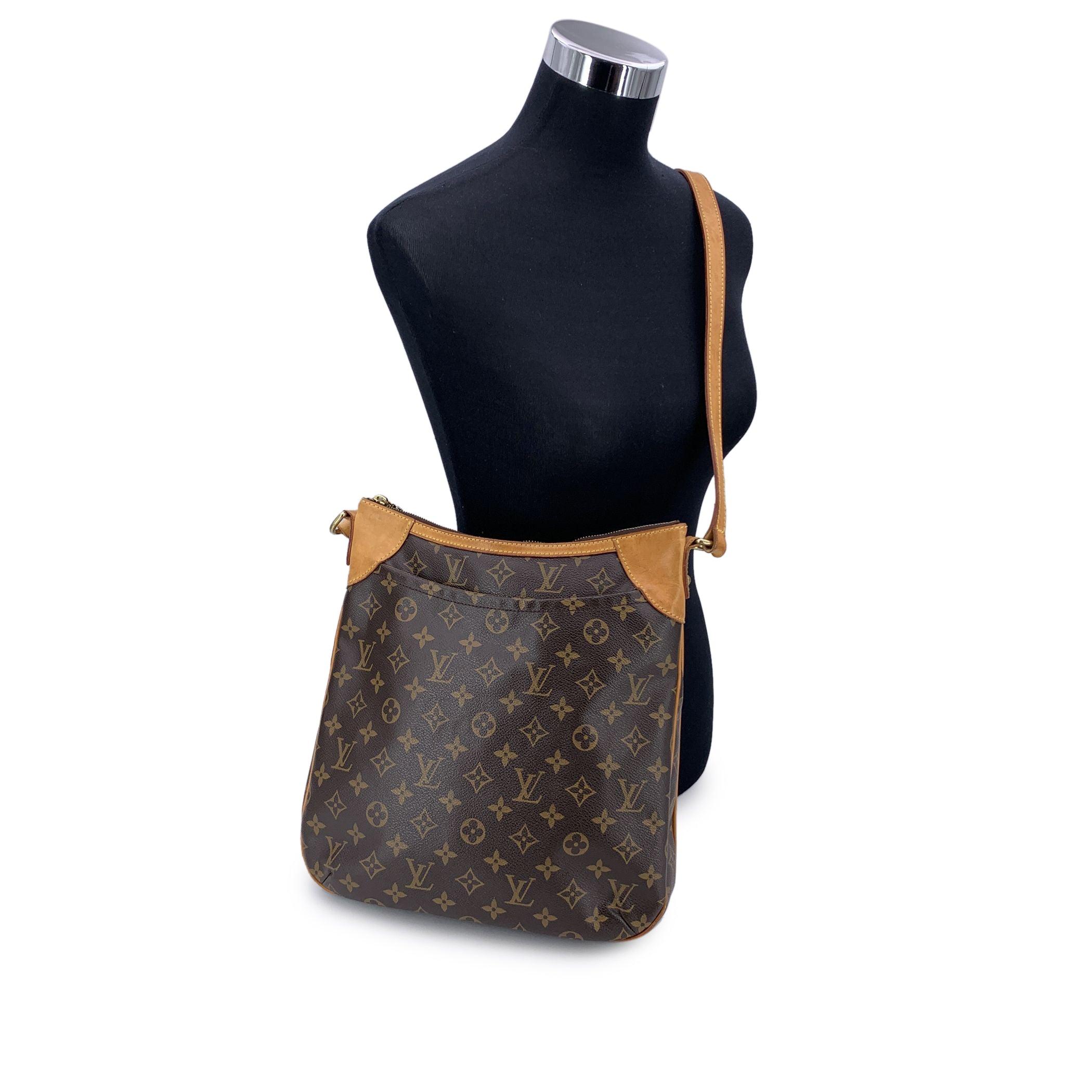 Discover the perfect blend of style and practicality with the LOUIS VUITTON 'ODEON MM' shoulder bag, a true icon of timeless design. Crafted from the signature LV monogram canvas, this bag is beautifully accented with tan leather trim and polished