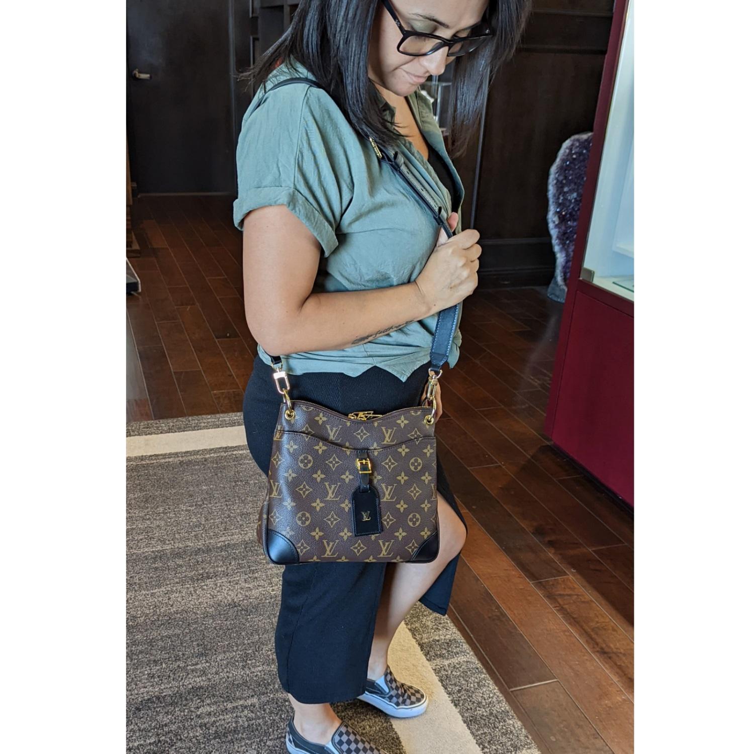 This messenger bag is crafted of signature Louis Vuitton monogram coated canvas, with black leather trim. The bag features an adjustable shoulder strap with gold-tone hardware and a flat front pocket for extra storage. The top zipper opens to a