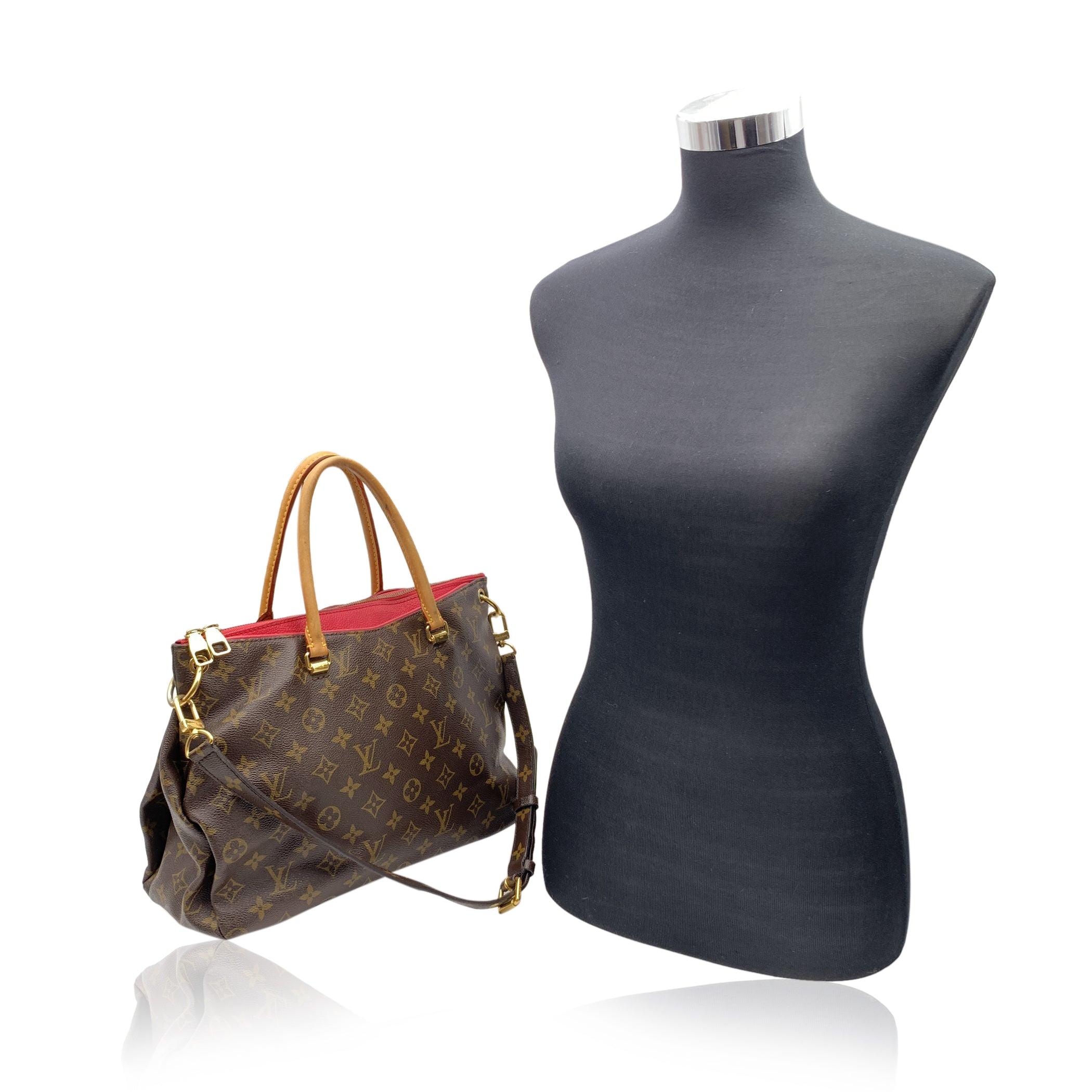 Louis Vuitton 'Pallas Full' in monogram canvas with fuchsia leather. Vacchetta leather handles and monogram canvas adjustable shoulder strap. Gold metal hardware. Upper zipper closure. 1 pocket with magnetic button closure on the front and 1 on the