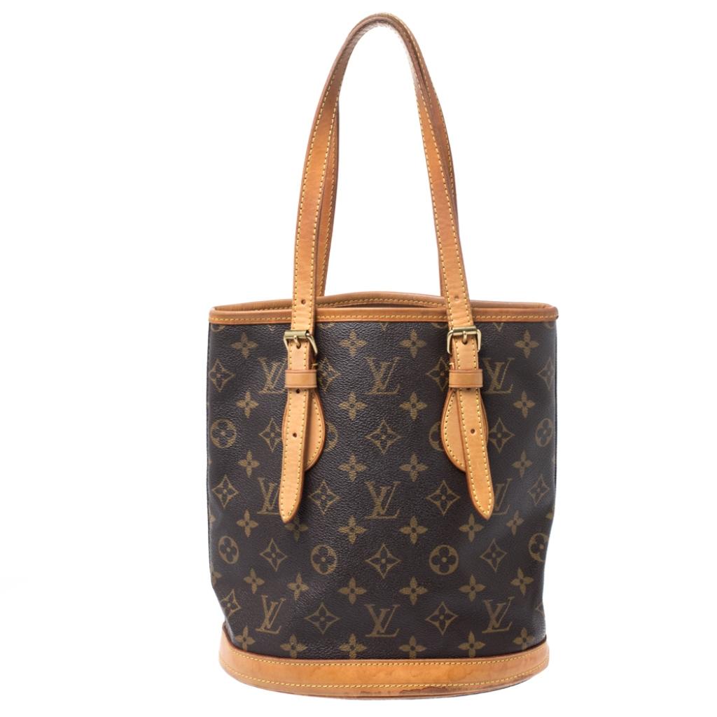 This Loius Vuitton bag flaunts the brand's rich heritage. Crafted from the house's signature Monogram canvas, it comes in a lovely shade of brown. This petit bucket bag features dual top handles crafted from leather, an open-top that leads to a