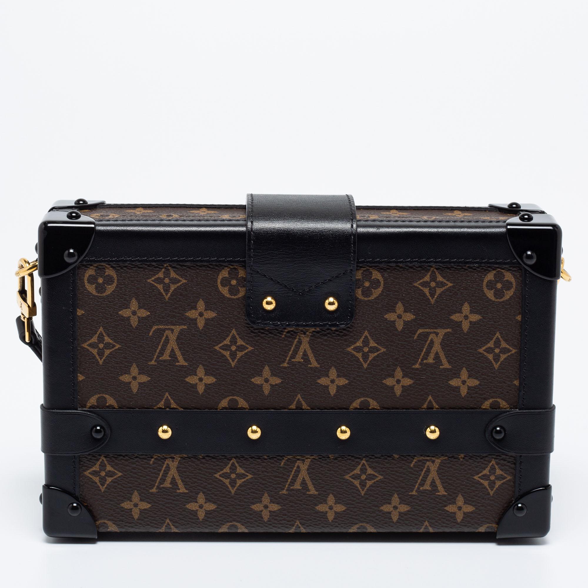 This Petite Malle bag from the House of Louis Vuitton brings you endless style, comfort, and luxury. It is crafted using Monogram canvas and displays gold-tone embellishments, a leather-lined interior, and leather trims. Its shape is complemented by