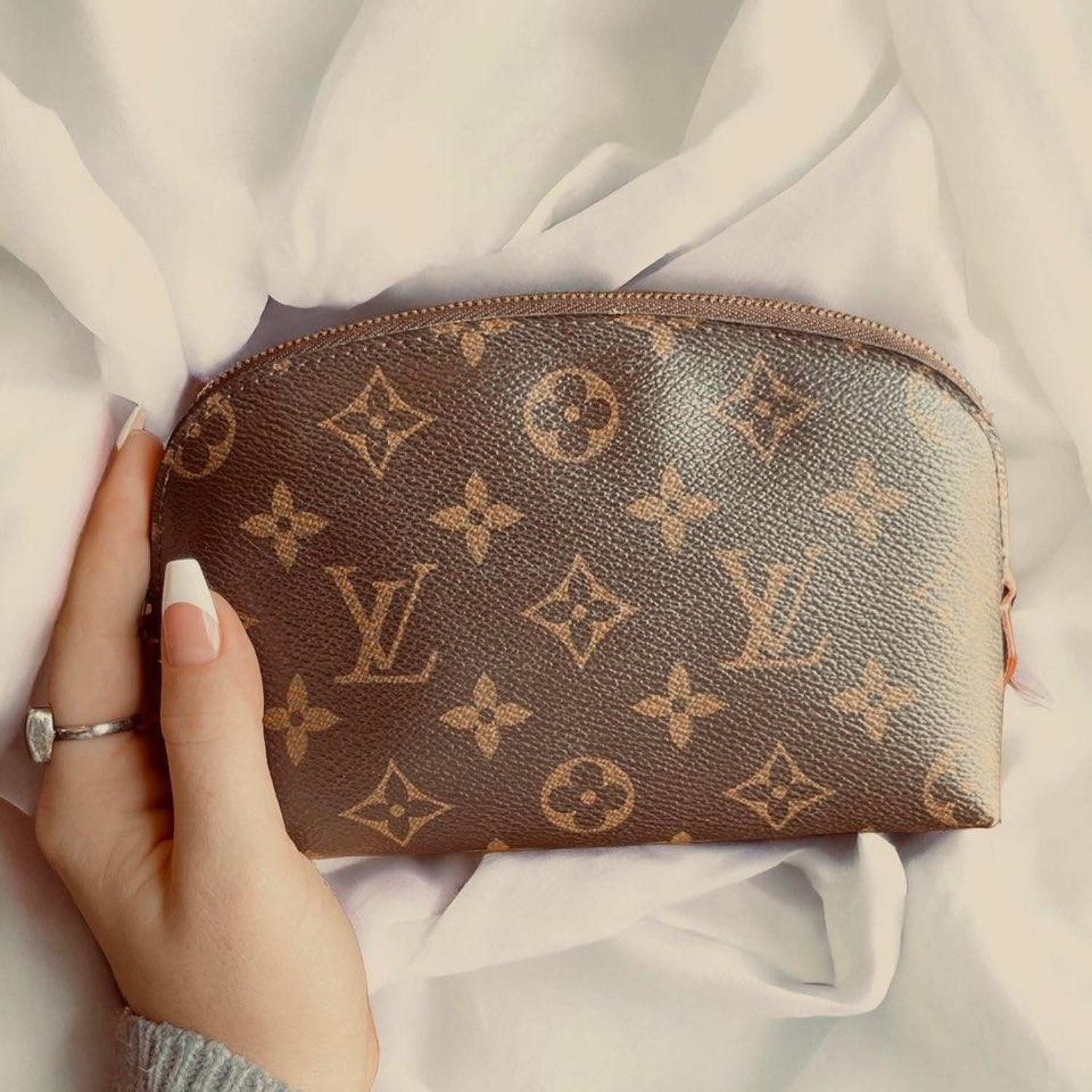 This compact cosmetic pouch in Monogram canvas slips easily into a handbag or suitcase. Its round shape and flat base facilitates access to small products.

Designer: Louis Vuitton
Material: Monogram coated canvas
Date/Authenticity Code: CA0172
Year