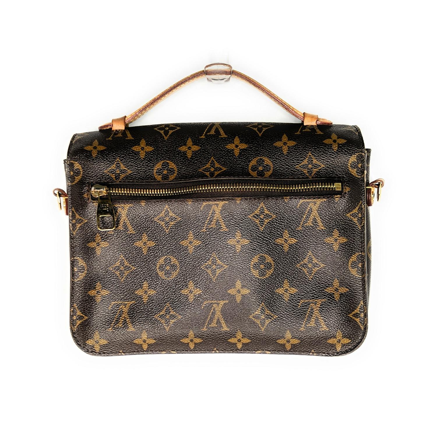 Brown and tan Monogram coated canvas Louis Vuitton Pochette Metis with brass hardware, tan Vachetta leather trim, single flat optional adjustable shoulder strap, single flat top handle, single zip pocket at back, chocolate Alcantara lining, three