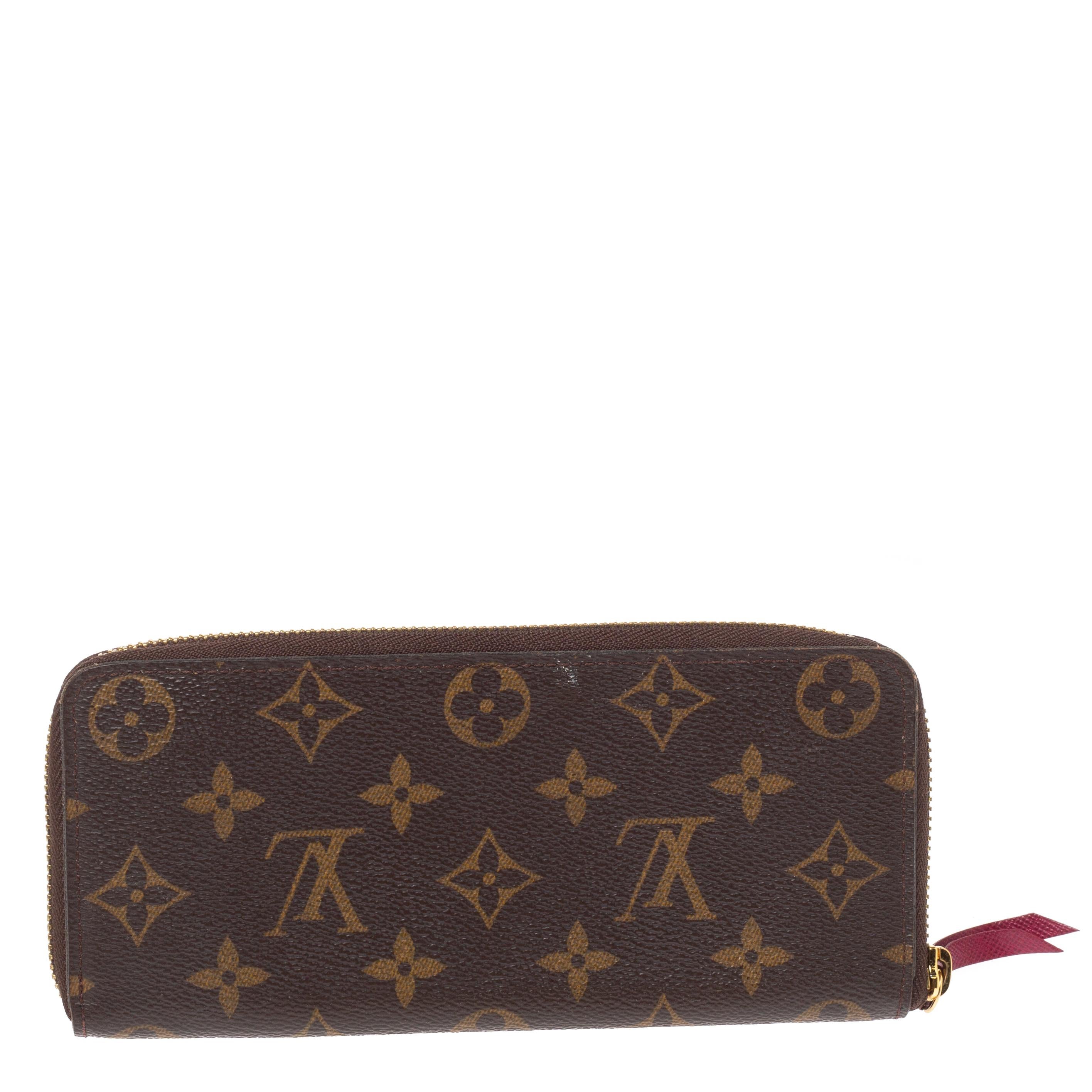 Fashionably put together, the brown hue of this wallet by Louis Vuitton gives it a signature feel. Crafted with monogram coated canvas, it is designed in a zip-around style with contrasting zip pulls. The insides are lined with leather and are