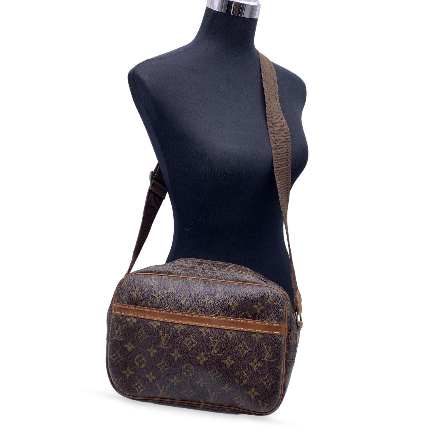 LOUIS VUITTON 'Reporter PM' crafted in timeless monogram canvas with vacchetta leather trim. It features 1 large open pocket on the front. Golden brass hardware and adjustable canvas shoulder strap. 2 main compartments with zip closure. Inside it